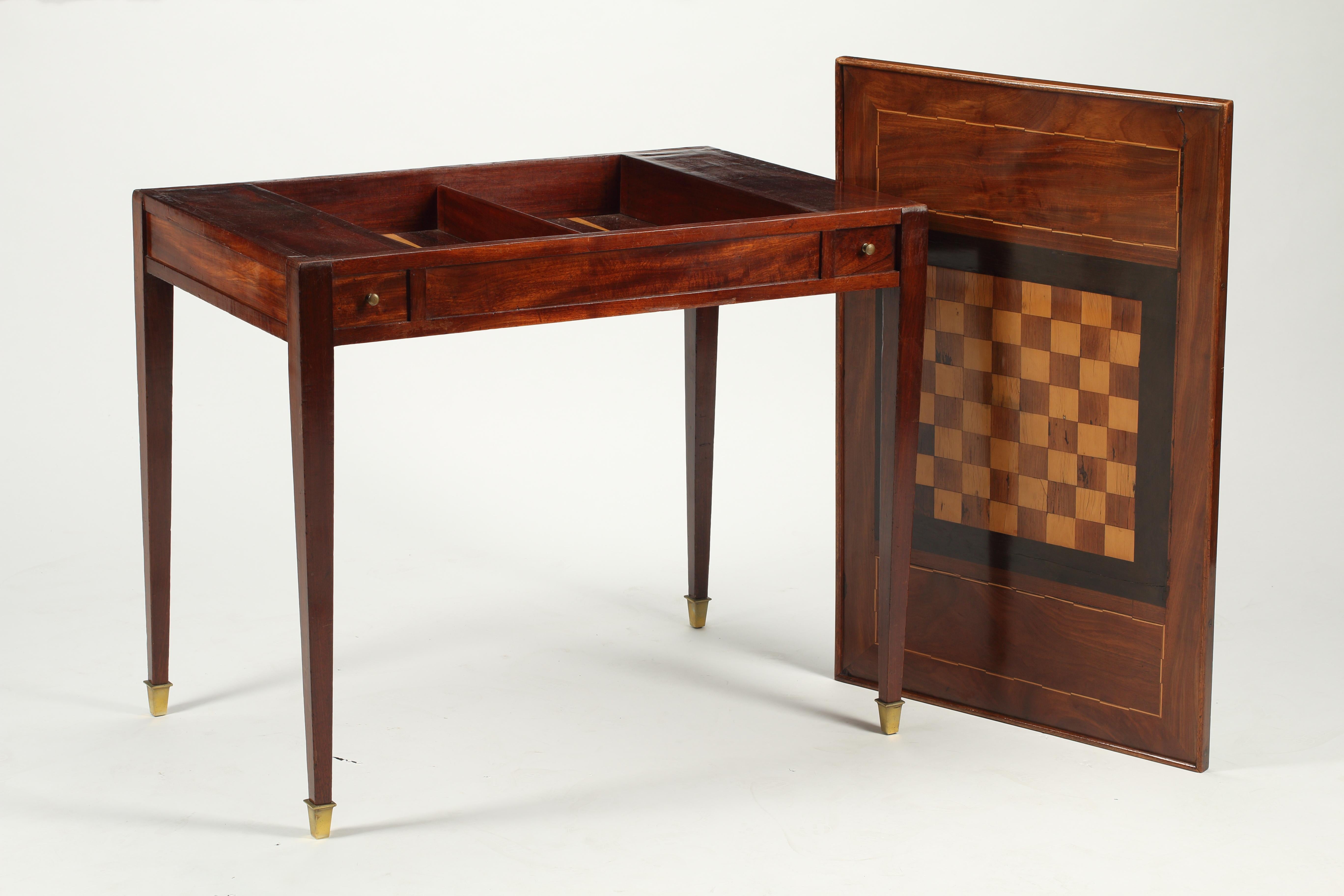 19th century French Empire period Tric Trac Games Table. The top features an inlaid checkerboard with delicate veneered inlays framing each players side. When flipped over, inset green felt top allows players to enjoy card and other games. Removing