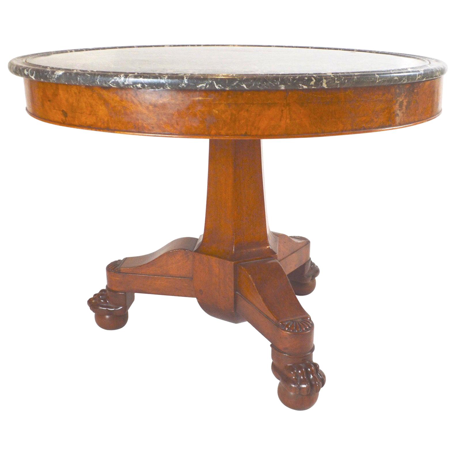 19th century French Empire walnut center or dining table with bun feet marble top.