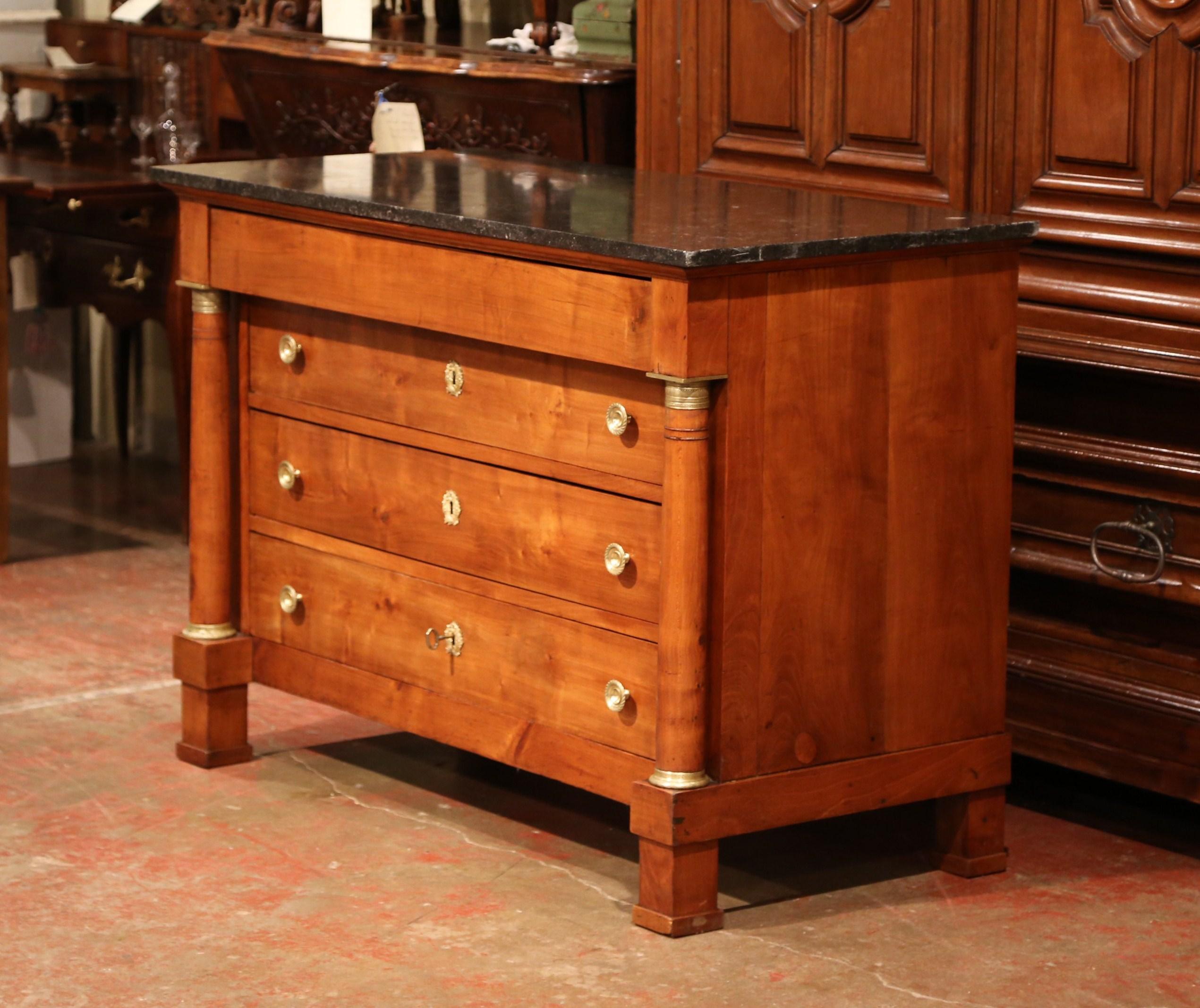 This elegant fruitwood chest of drawers was crafted in France, circa 1860. The traditional antique commode features three drawers across the front with original bronze pulls and decorative key holes escutcheons, and a fourth additional drawer under