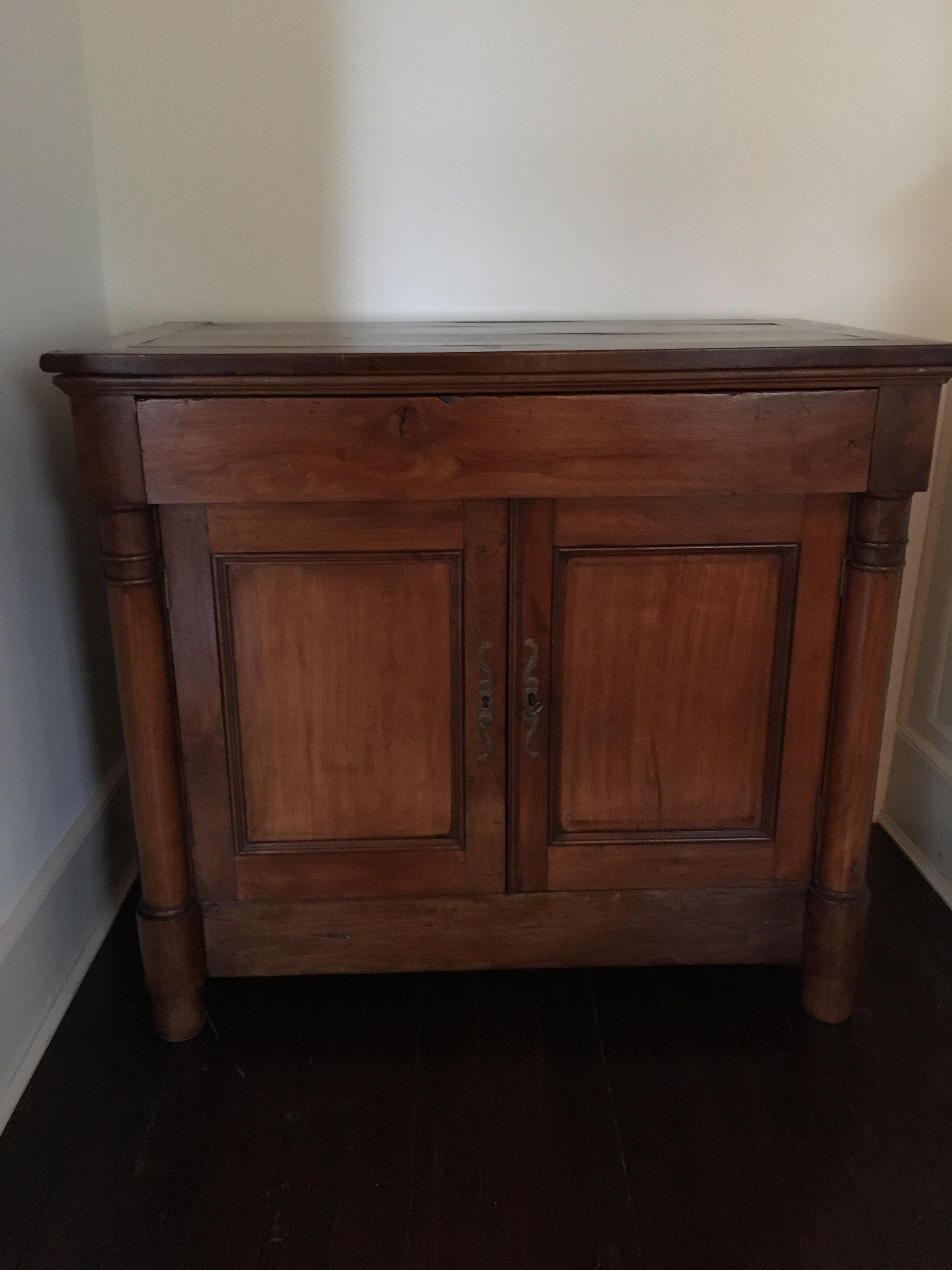19th century French Empire walnut sideboard. Single drawer and two doors with a single shelf below.
Original hardware and key.