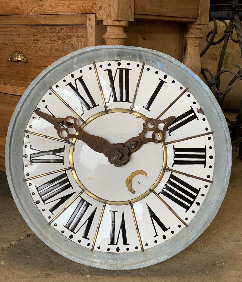 A lovely 19th century French church clock face. The clock is made from wood with an enamelled copper face with a zinc border. With original metal hands and mechanical movement which is no longer working. 
It is now a beautiful decorative piece and