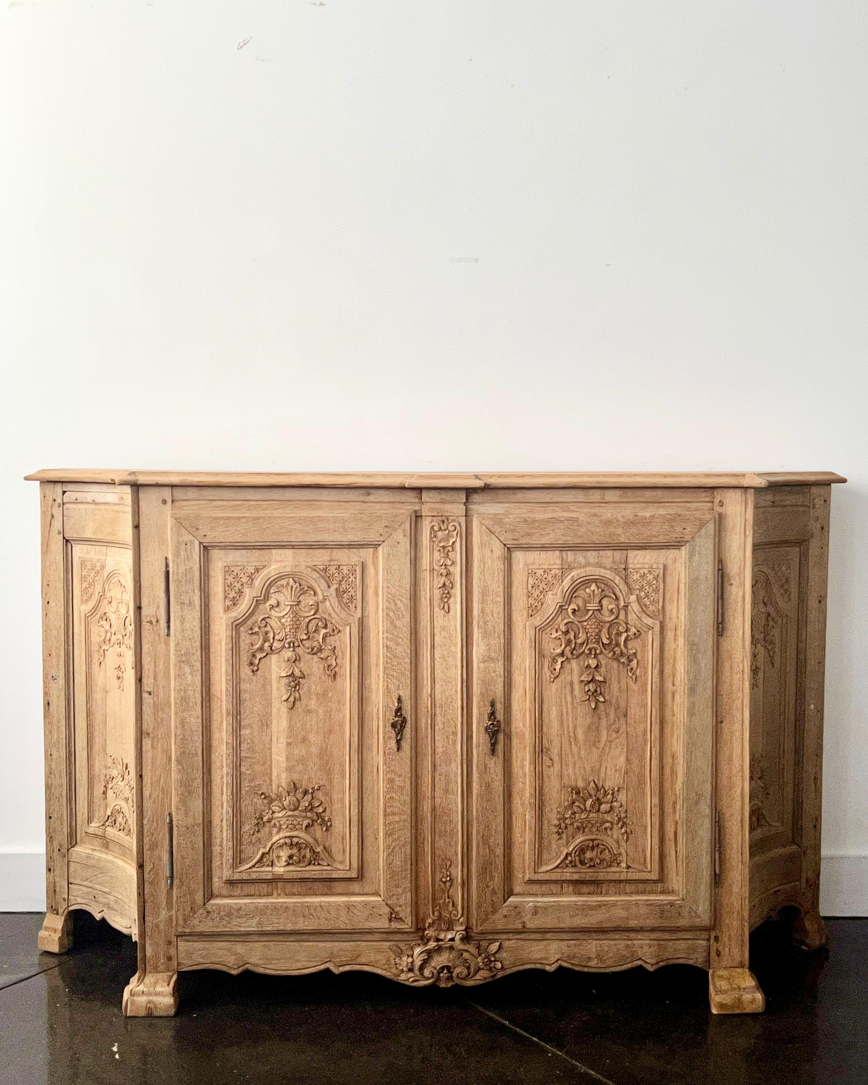 19th century French enfilade or sideboard, in Louis XV manner with shaped top and richly carved fielded door panels on front carved feet in worn stripped oak wood with a rustic ironwork.
France, late 19th century.
More than ever, we selected the