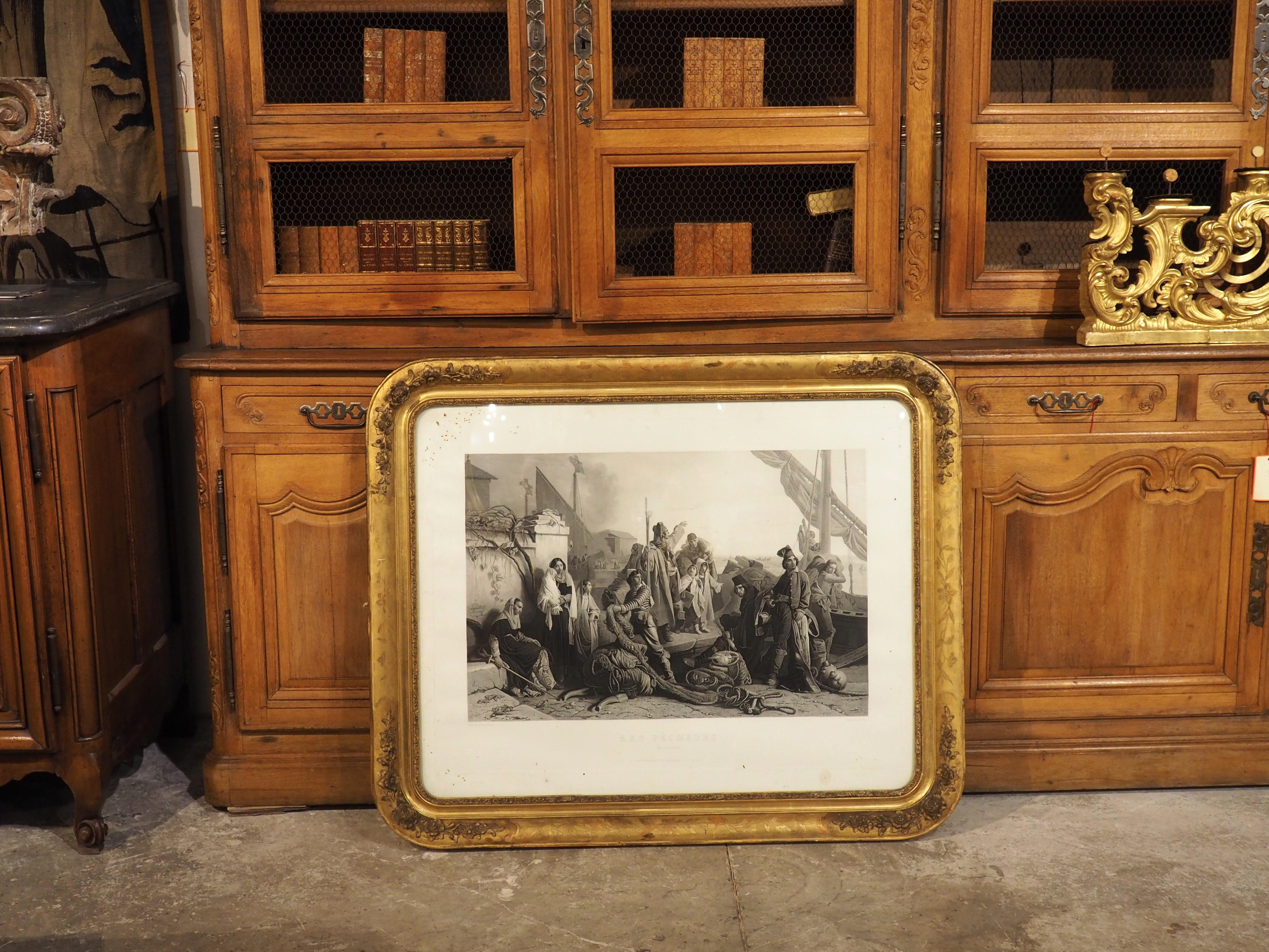 Entitled Les Pecheurs de L’Adriatique (“The Fishermen of the Adriatic”), this 19th-century engraving is after the original 1834/1835 painting by Léopold Robert. The print is encased in glass and surrounded by a wonderfully hand-carved giltwood frame