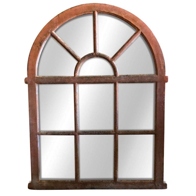 Early 19 century, French Orangerie wall mirror with an arched top, in good condition. The wall mount structure has a cast iron antique frame and newly inserted mirrored panels. Wear consistent with age and use. The antique wall décor represents the