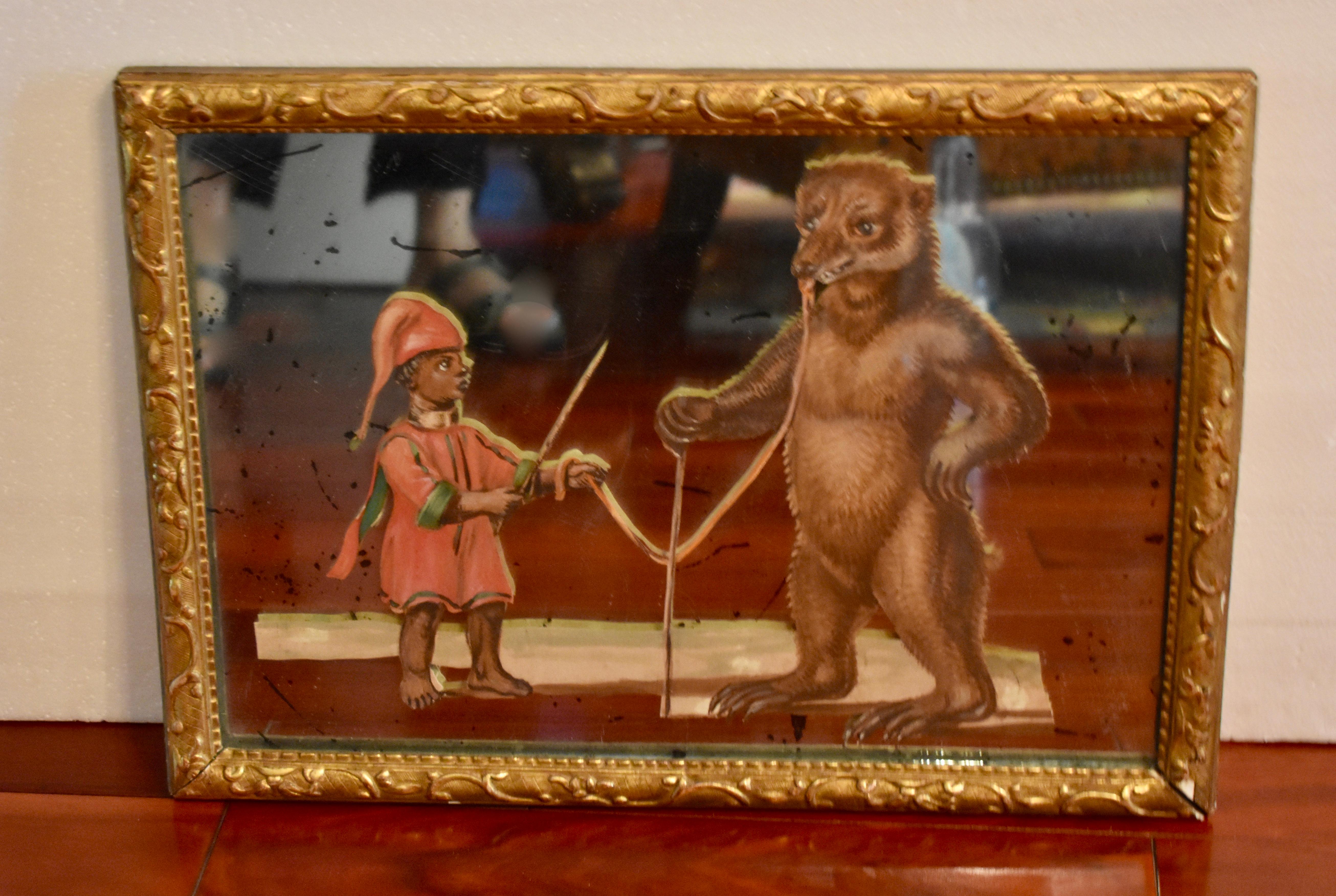 A unique 19th century French exotic themed, hand painted, decoupaged and mirrored depiction of a young animal trainer and his bear. 

The paper figural scene is cut and mounted between glass and a mirror backing, showing a boy training a standing