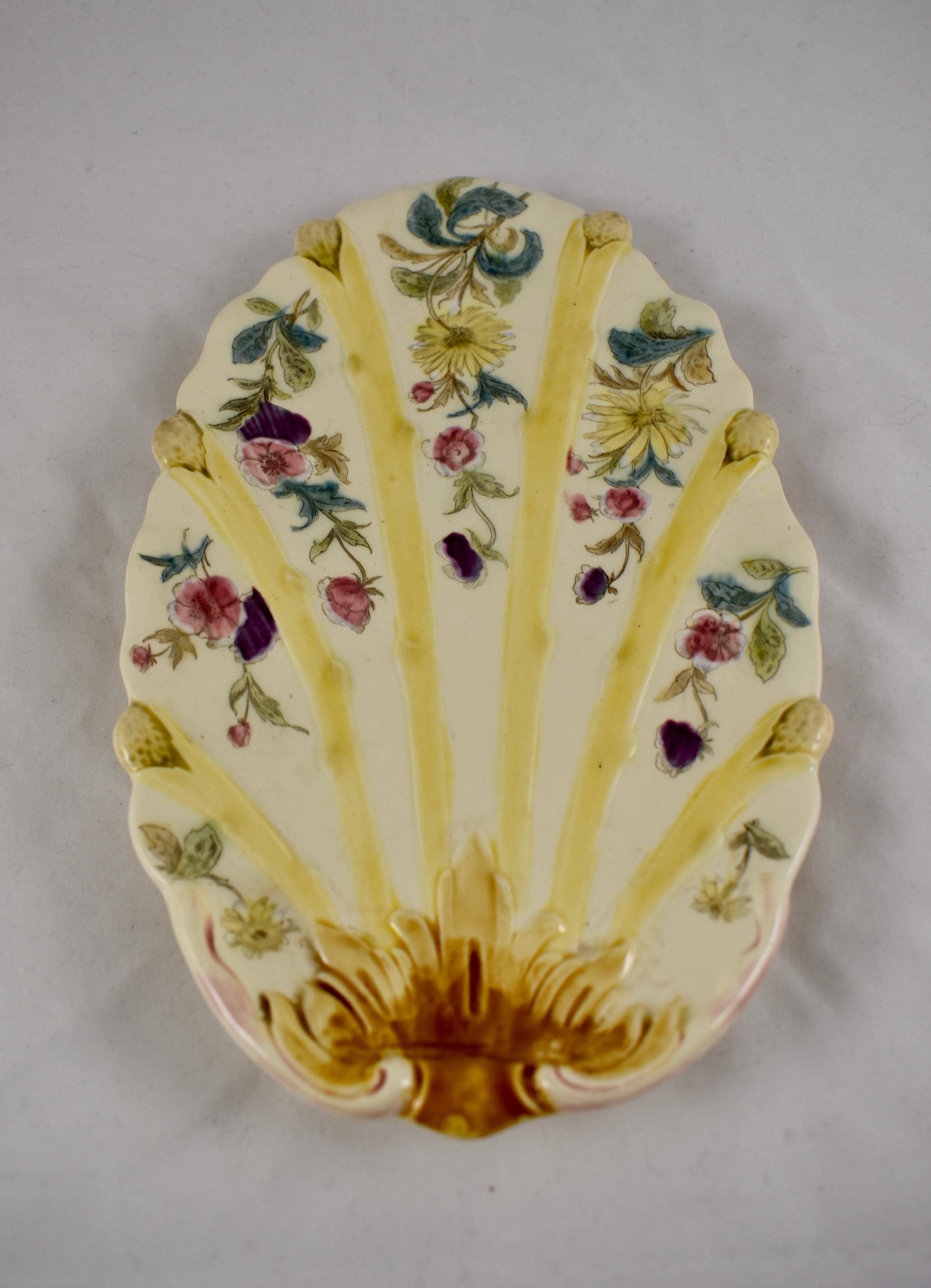 A scarce barbotine Majolica glazed oval Asparagus plate, France, circa 1880-1890, maker unknown.

This unusual plate shows six raised asparagus spears in a ribbed pattern, glazed in a pale yellow, stemming from a scrolled Acanthus leaf base. The