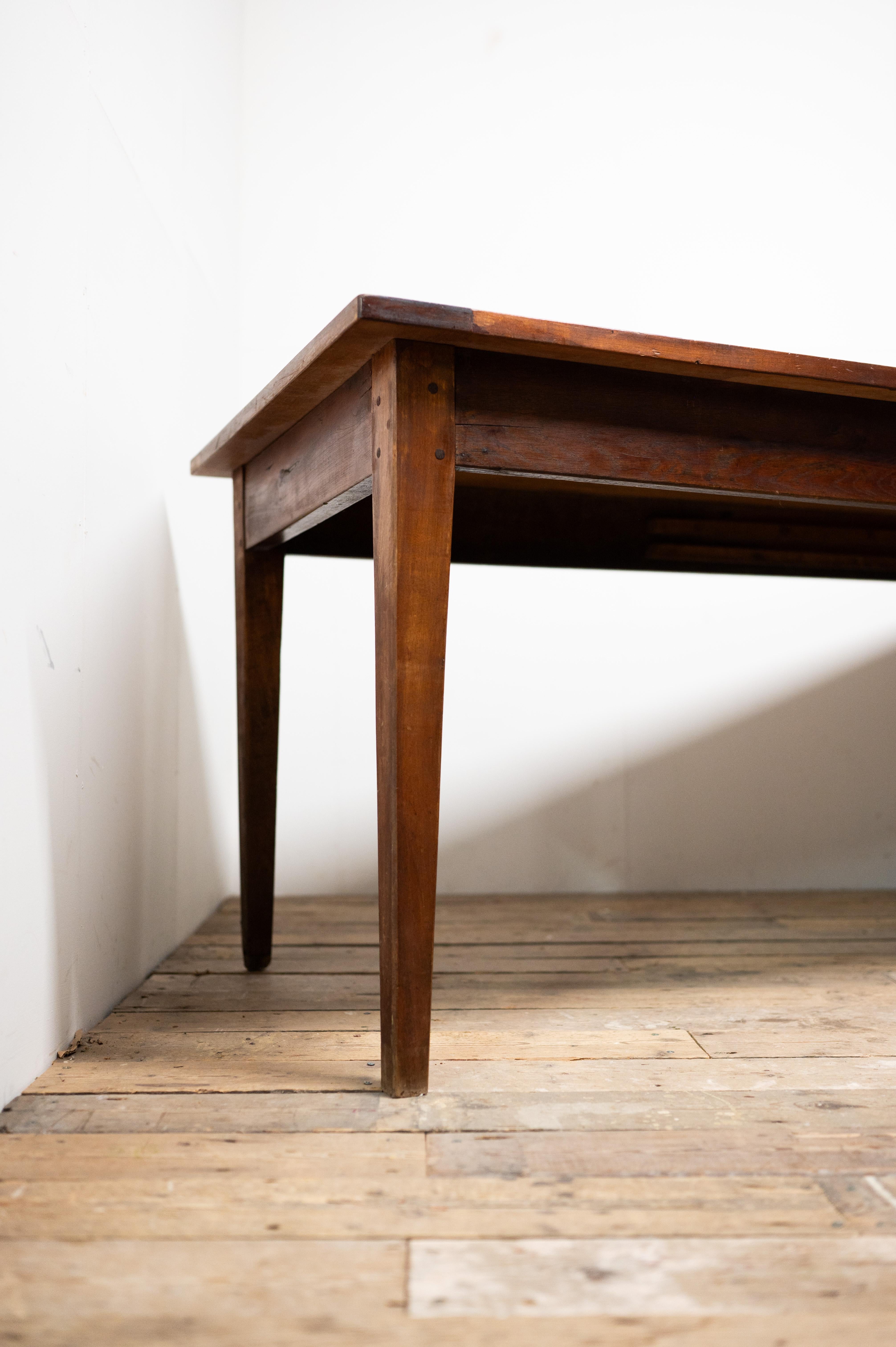 Introduce a piece of history into your home with this exquisite 19th Century French Farm Table, expertly crafted from rich cherry wood and boasting a wealth of character and patina.

This table is more than just a piece of furniture; it's a journey