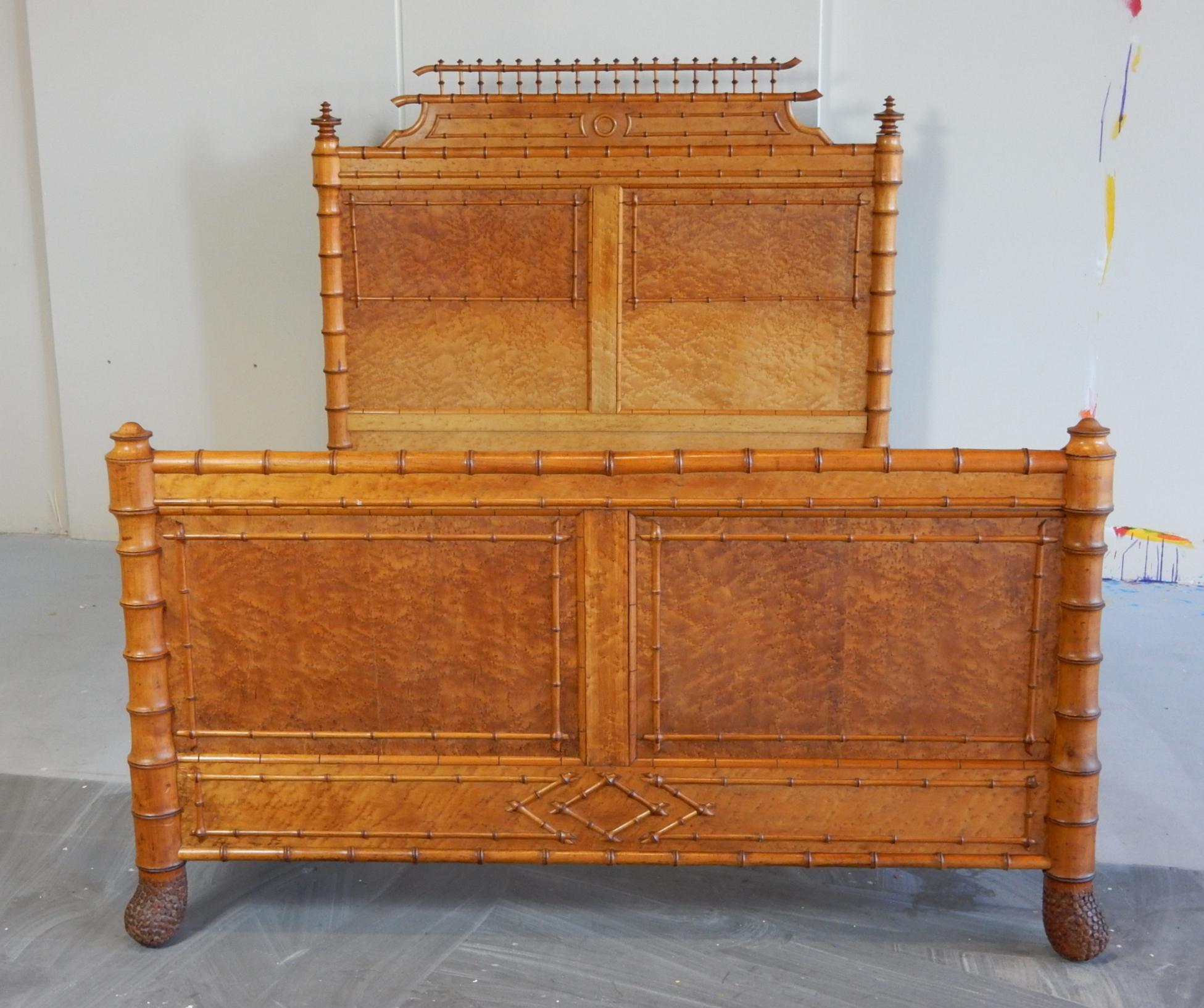 Magnificent artisan bed from the mid-19th century aesthetic movement era.
Made in France by a master carpenter with faux bamboo detail over gorgeous bird's-eye maple burl veneer.
Stylized bamboo legs tapper to a realistic, hand carved bamboo 