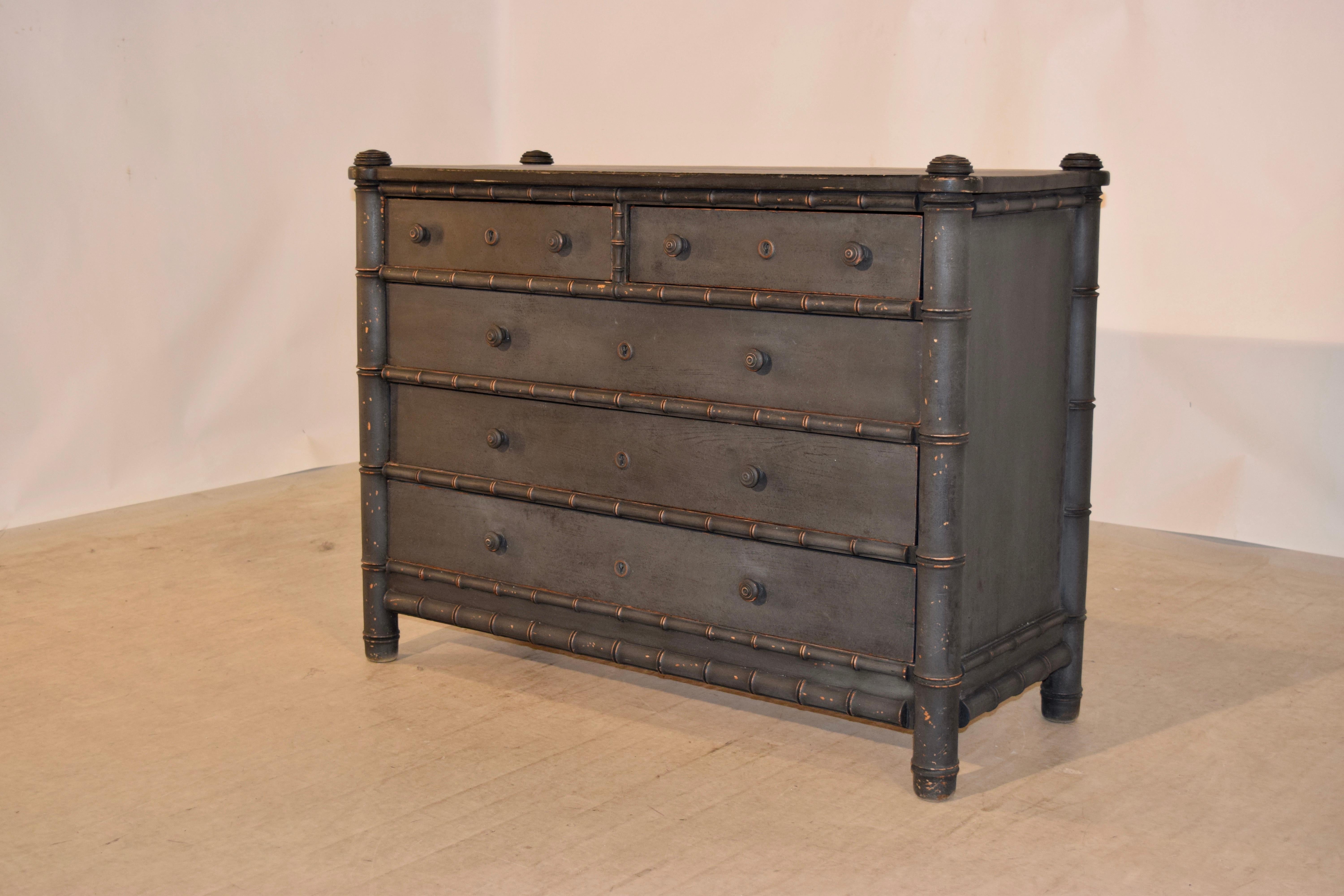 19th century faux bamboo chest from France with a shaped top which has lovely hand-turned caps, following down to simple sides framed by faux bamboo molding, and two over three drawers, separated by faux bamboo turned molding. The drawers are