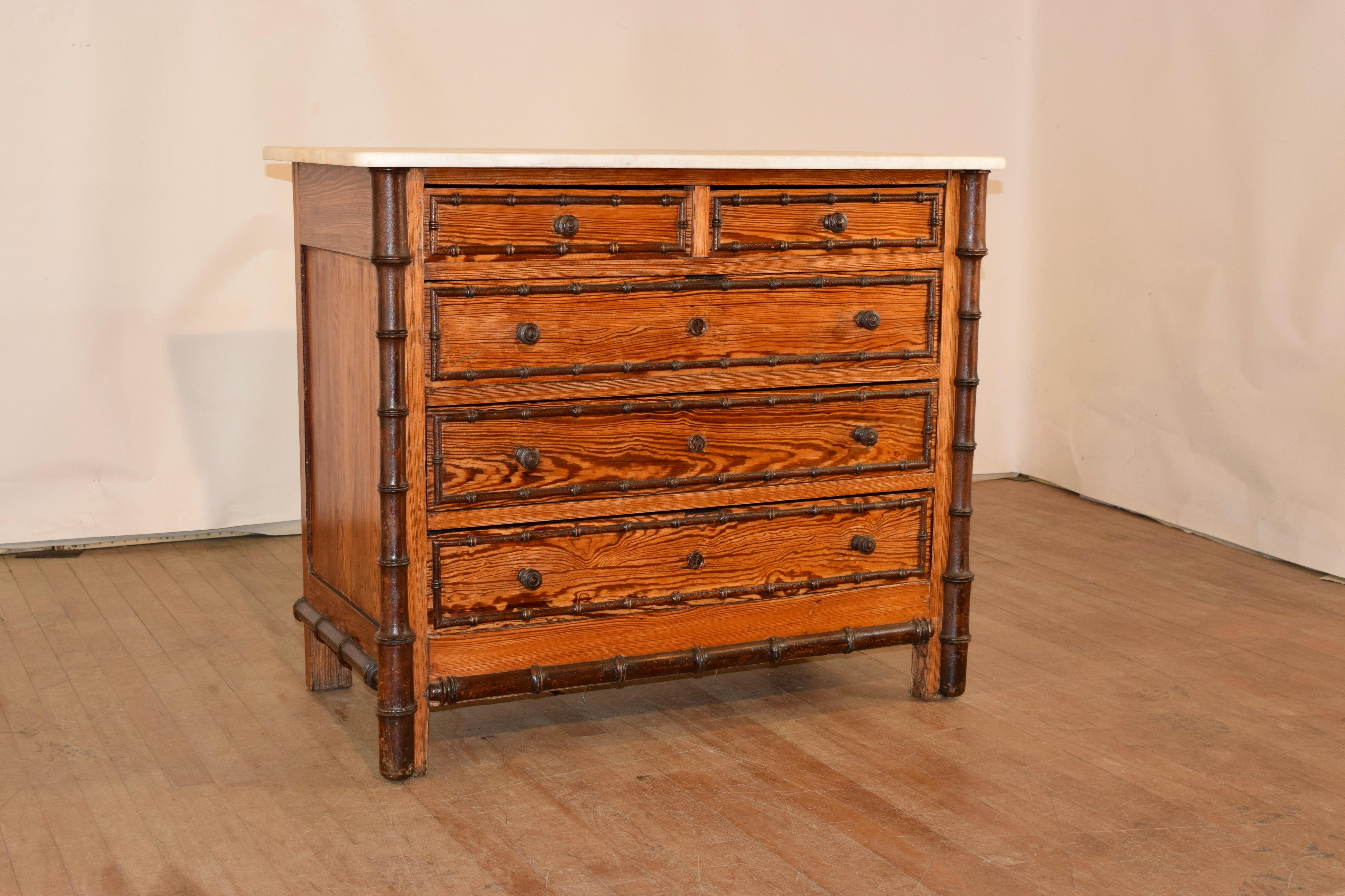19th century faux bamboo chest of drawers from France with a removable Carrara marble top, following down to a pitch pine case with hand turned cherry wood applied moldings. The case has two over three drawers flanked by hand turned cherry half