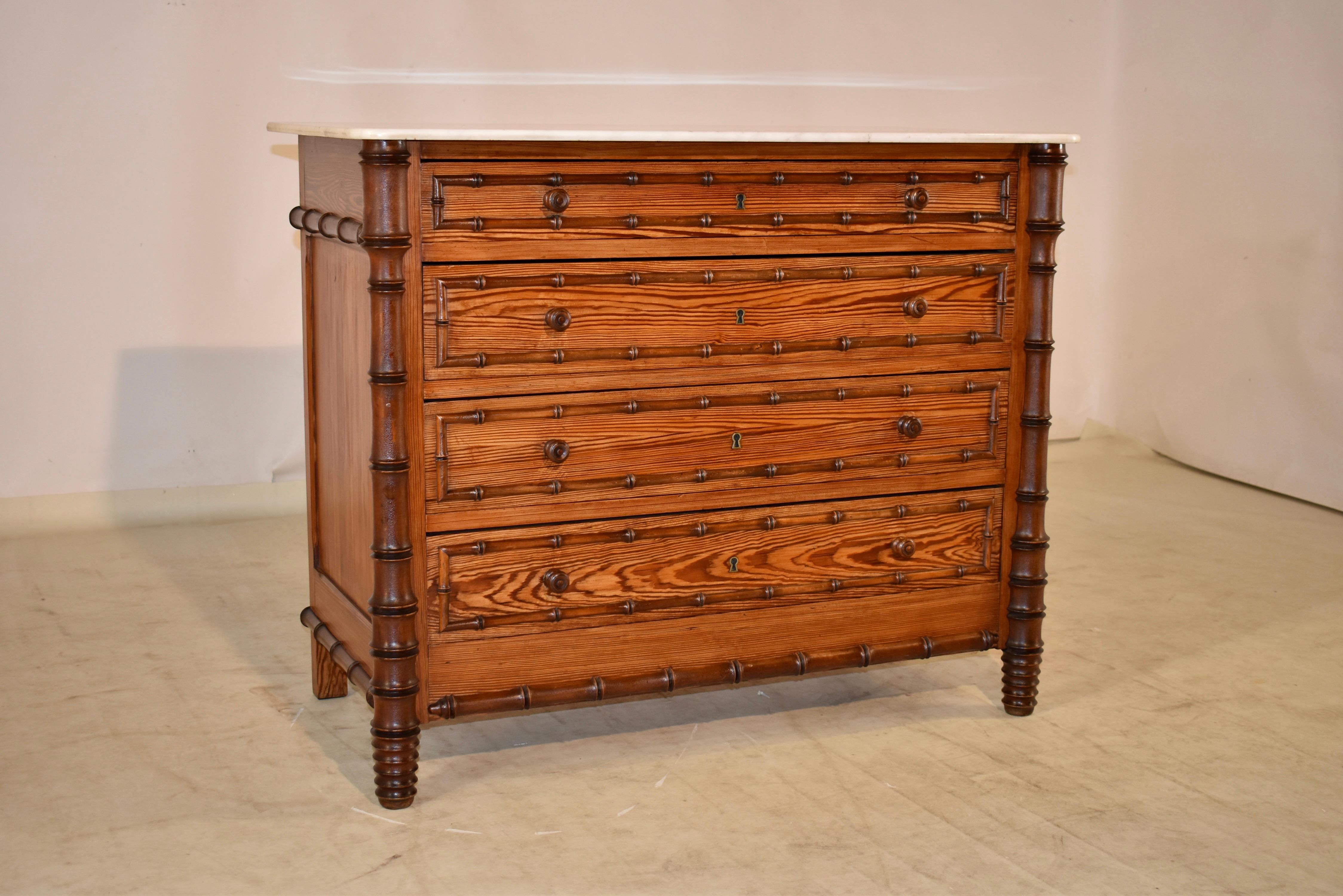 19th century faux bamboo chest of drawers from France with a removable Carrara marble top, following down to a pitch pine case with hand turned cherry wood applied moldings. The case has simple paneled sides with applied turned moldings. The case