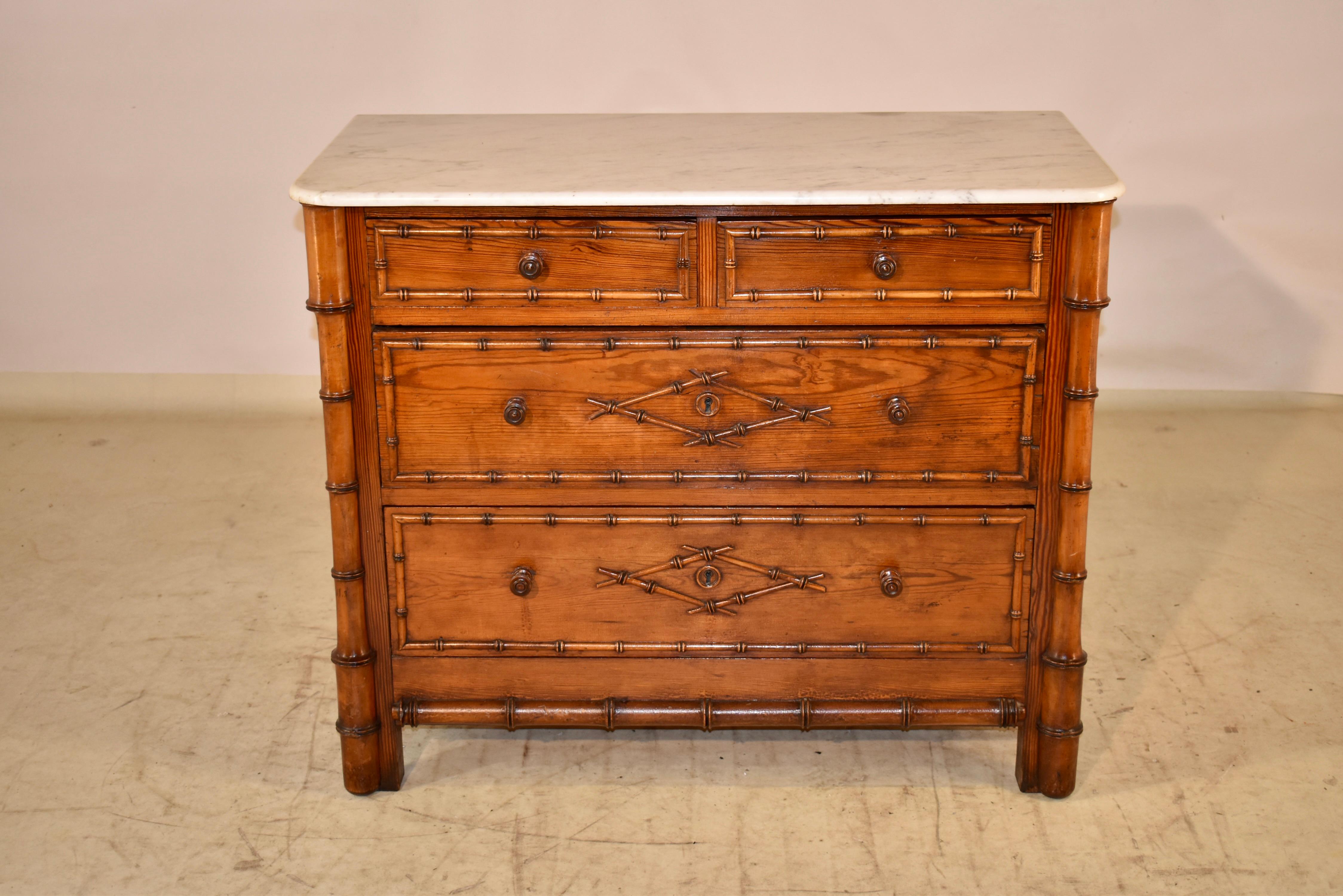 19th century pitch pine chest of drawers with faux bamboo decorative accents.  The top is made from Carrara marble, sitting on top of a lovely case.  The case has paneled sides with faux bamboo molding accents, and there are two drawers over two
