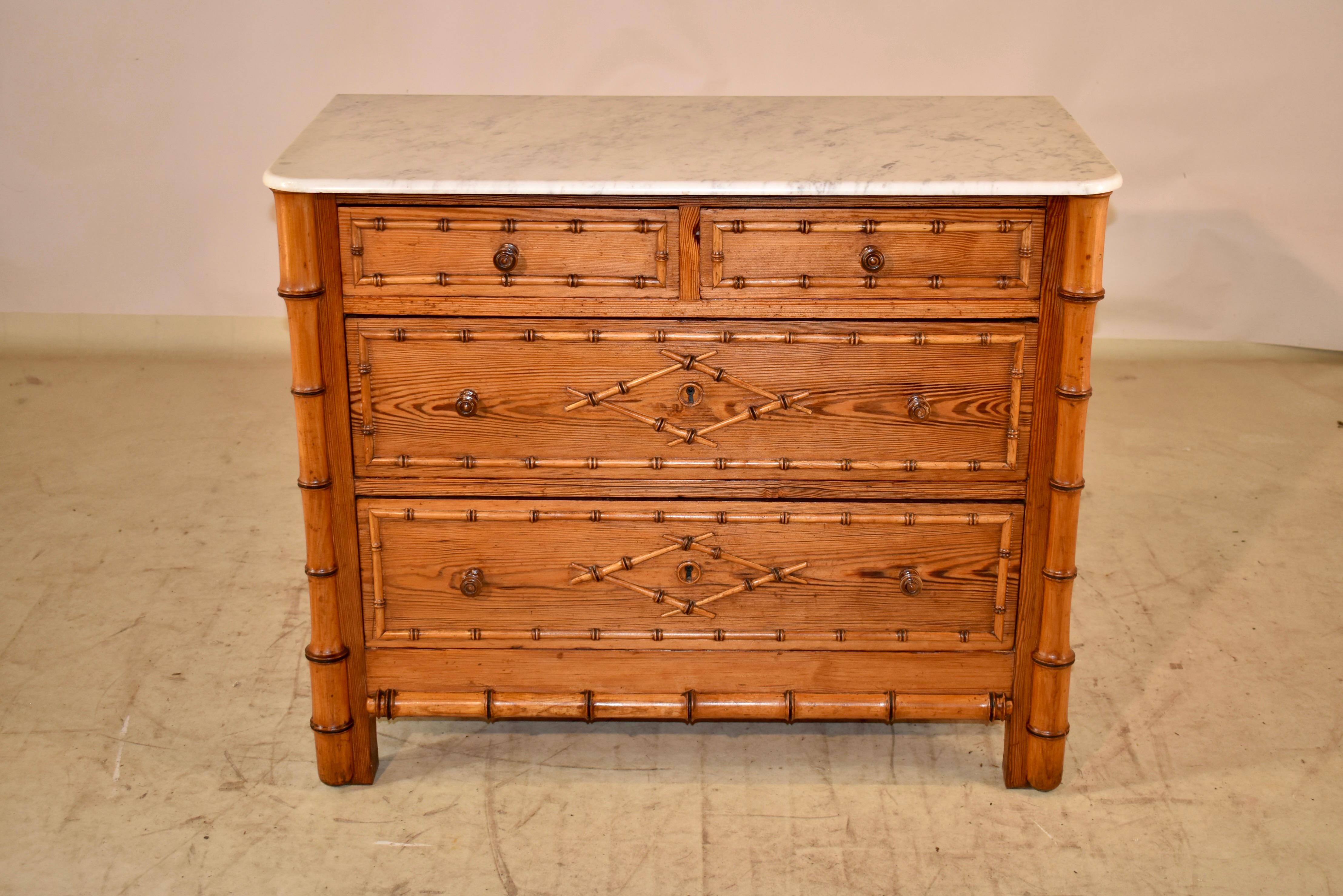 19th century faux bamboo chest of drawers from France.  The top is made from Carrara marble, and sits atop a case with simple paneled sides and faux bamboo molding at the bottom of the sides.  The front of the case has two drawers over two drawers,