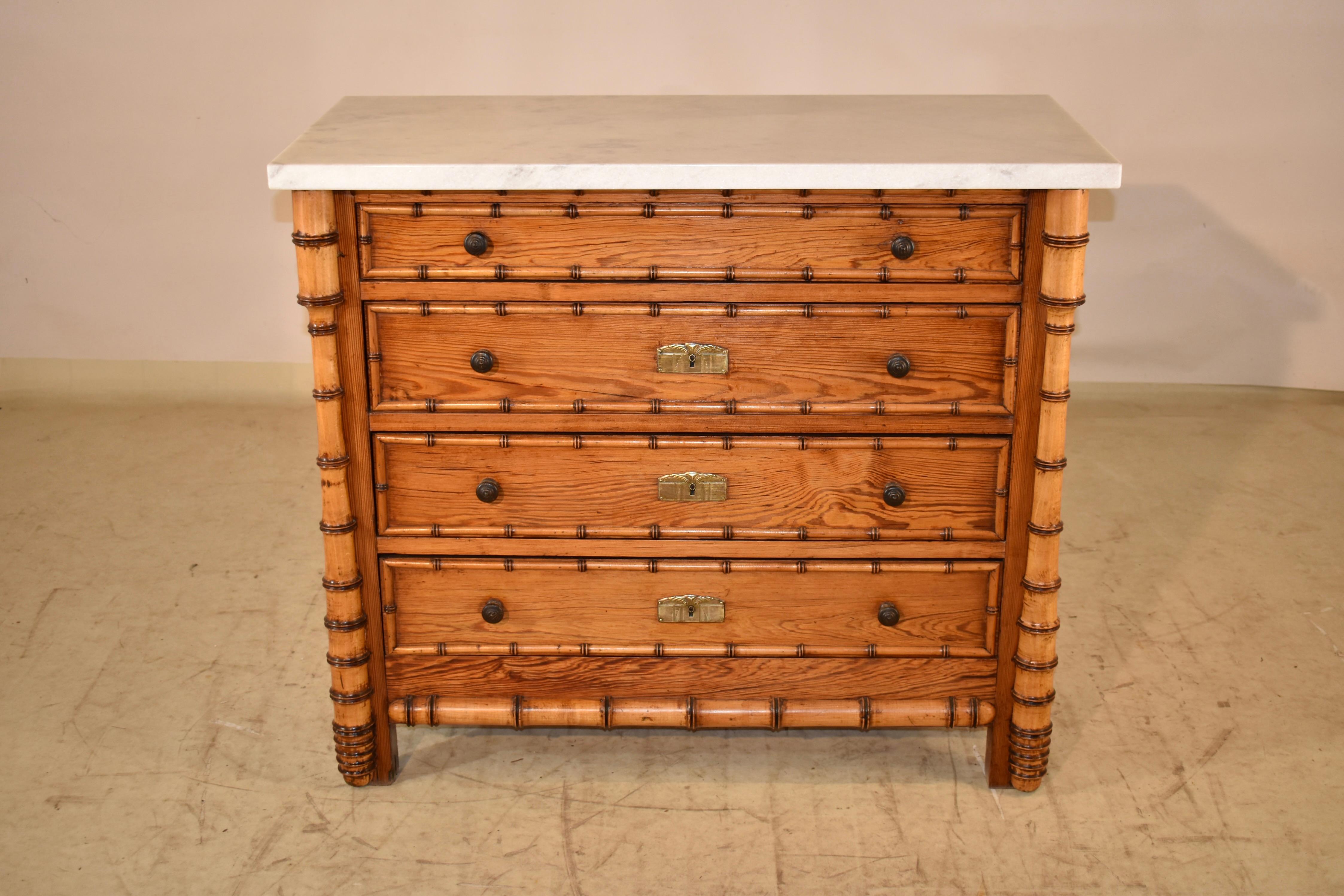 19th century chest of drawers from France.  The marble top is made from Carrara marble and has been replaced.  This piece has four drawers all with faux bamboo applied moldings turned from cherry.  The chest is made from pitch pine, and has gorgeous