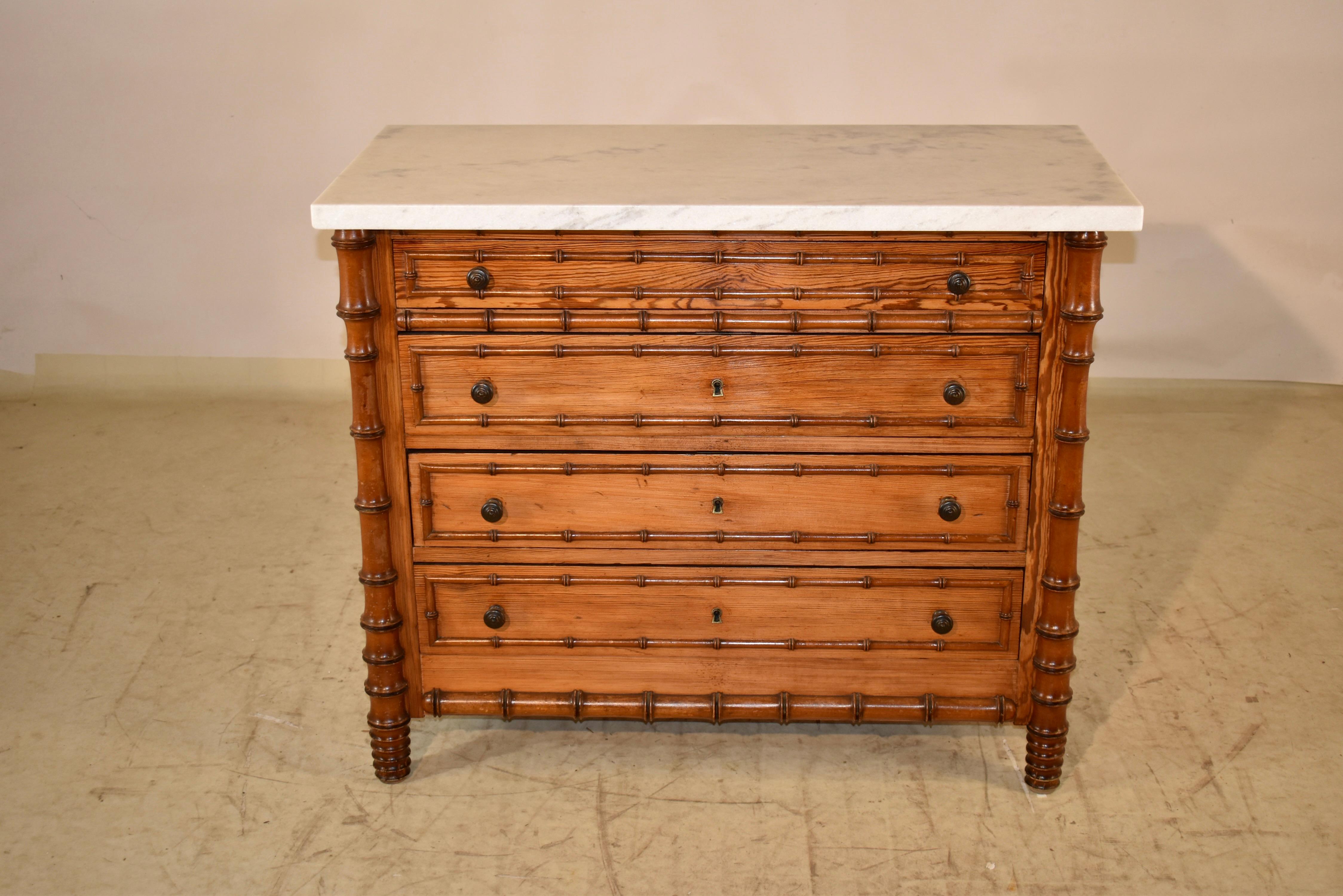 19th century faux bamboo chest of drawers from France.  The top has been replaced with Carrara marble, and sits upon the case, which is made of pitch pine.  The chest has four drawers, and all of the drawers have hand turned cherry moldings that