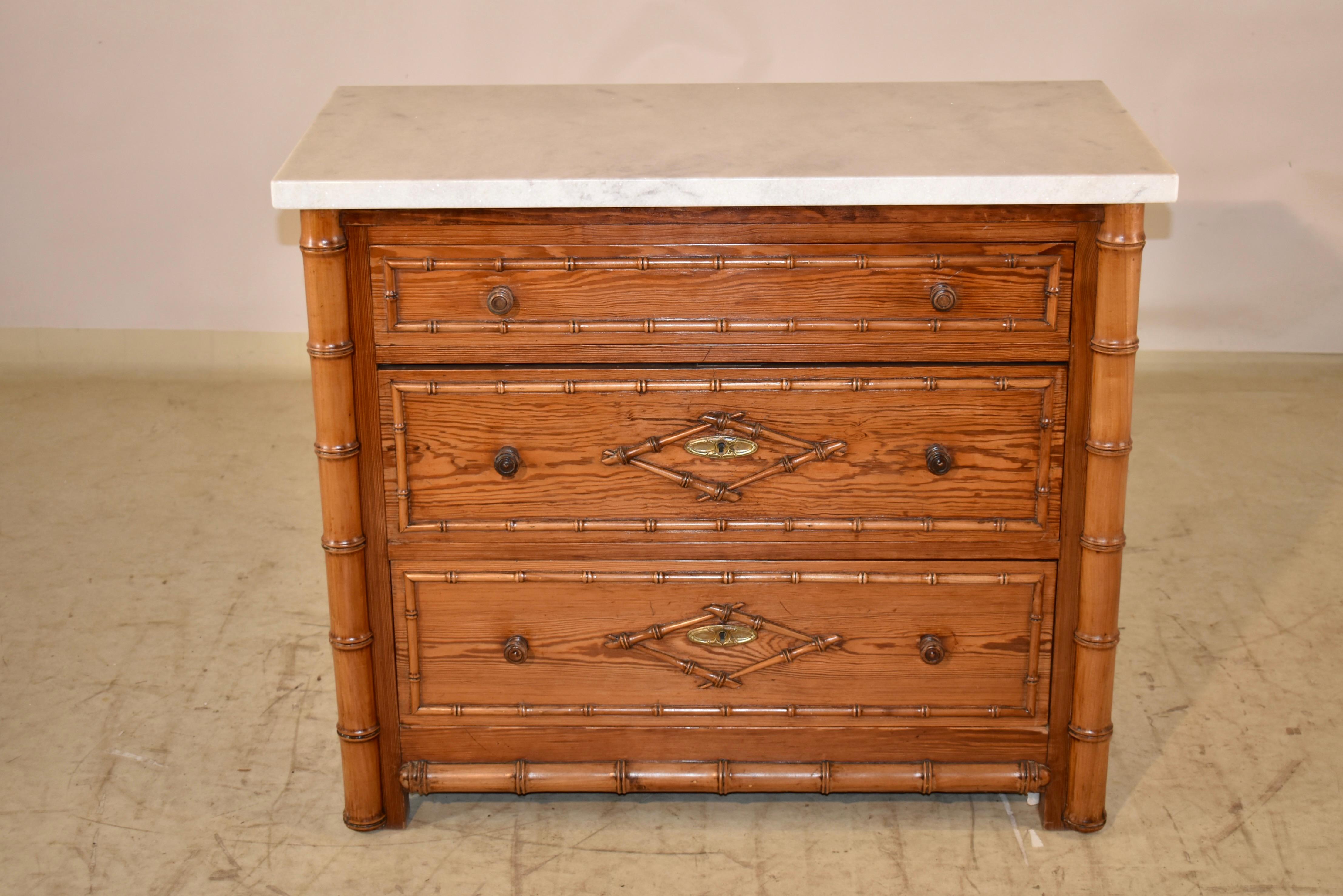 19th century faux bamboo chest of drawers from France.  The top is new and  is made from Carrara marble.  The sides of the chest are simple and paneled , and are finished at the bottom with an applied hand turned faux bamboo style molding.  The