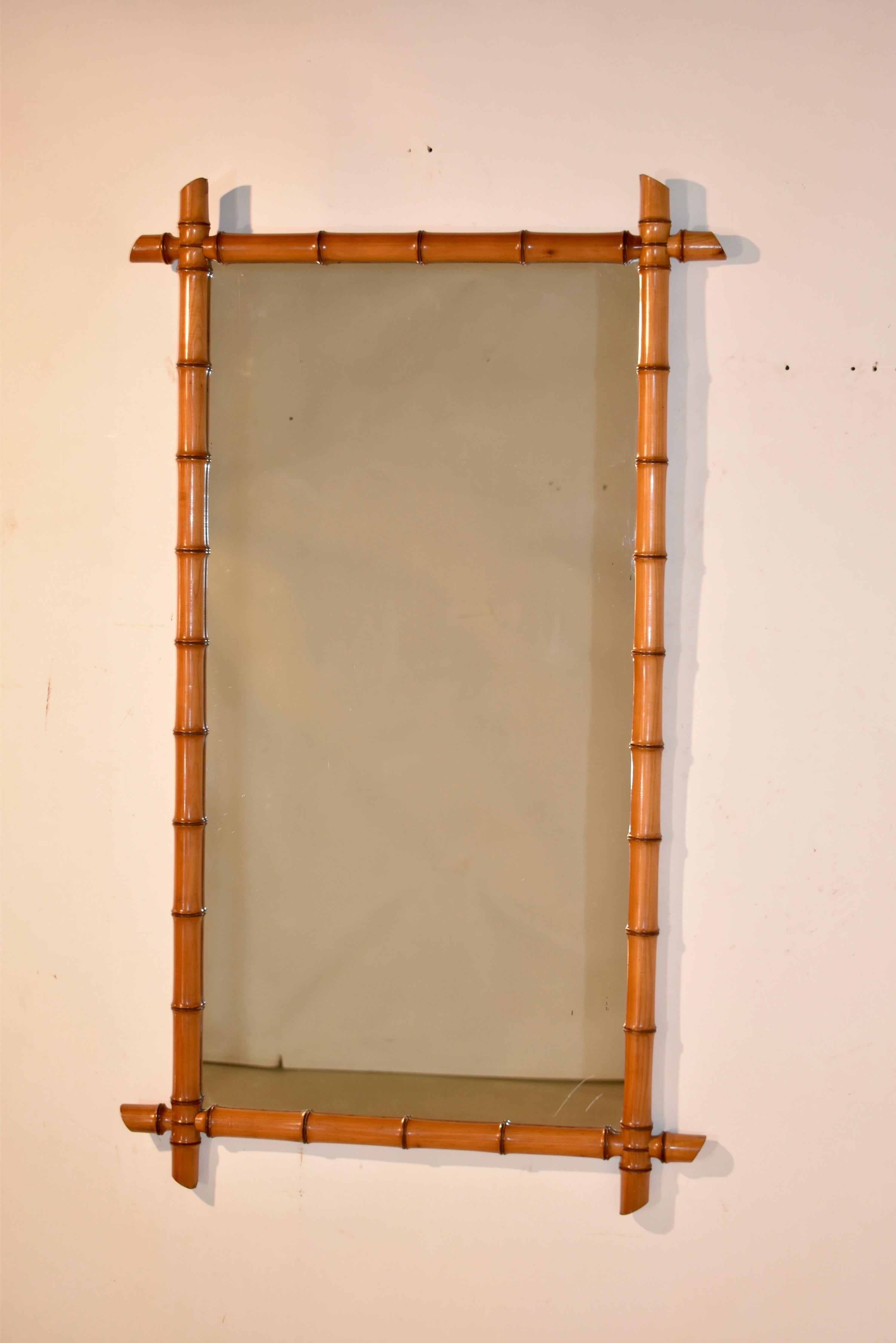 Grande specchio da parete in finto bambù del XIX secolo proveniente dalla Francia.  La cornice dello specchio è tornita a mano nel popolarissimo stile finto bambù, indicativo del periodo Art Nouveau in Francia.  Lo specchio presenta i normali segni