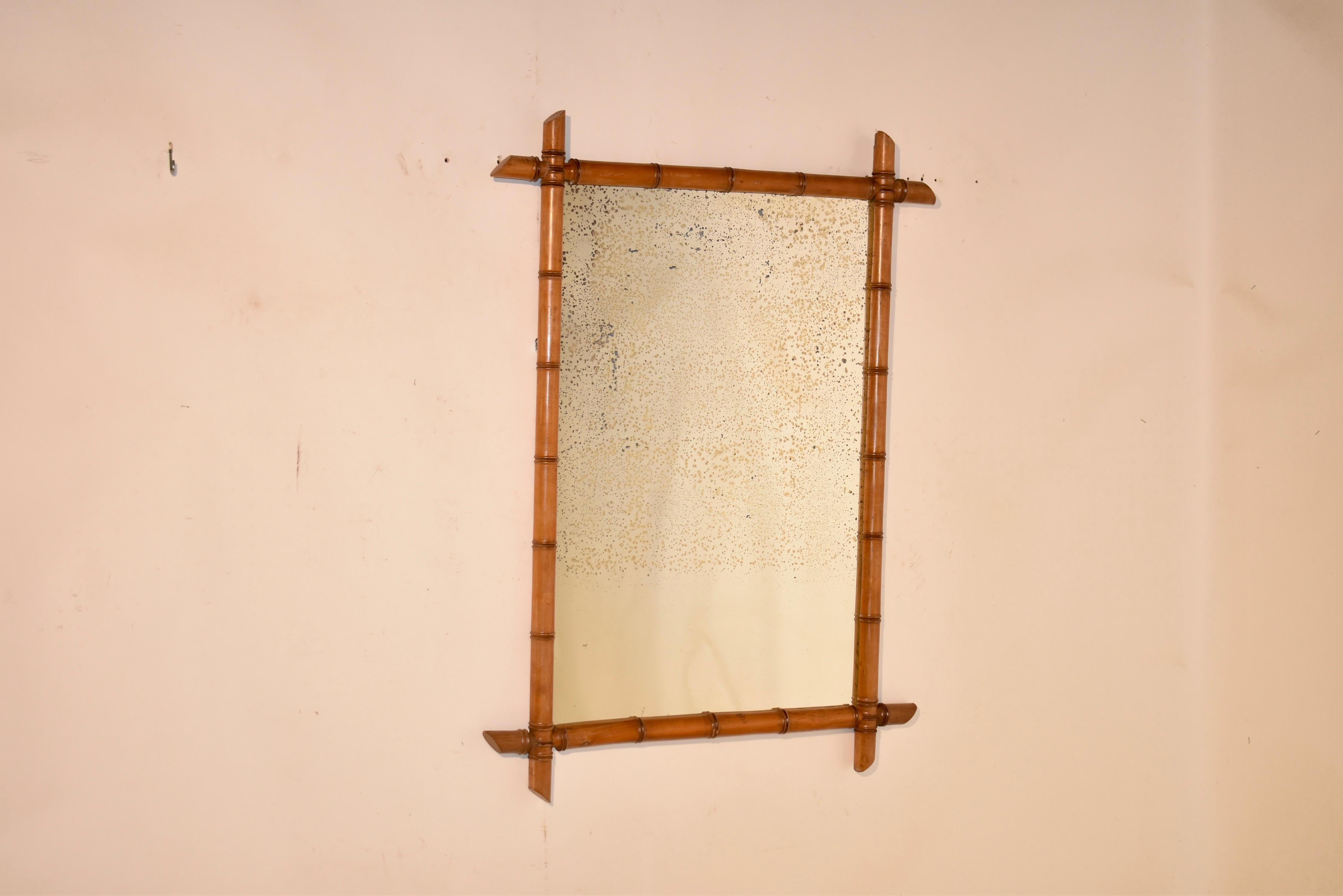 19th century faux bamboo mirror from France.  The frame has been wonderfully hand turned from cherry to look like bamboo.  The frame surrounds what appears to be the original mercury glass mirror.  These mirrors are wonderful for adding depth and