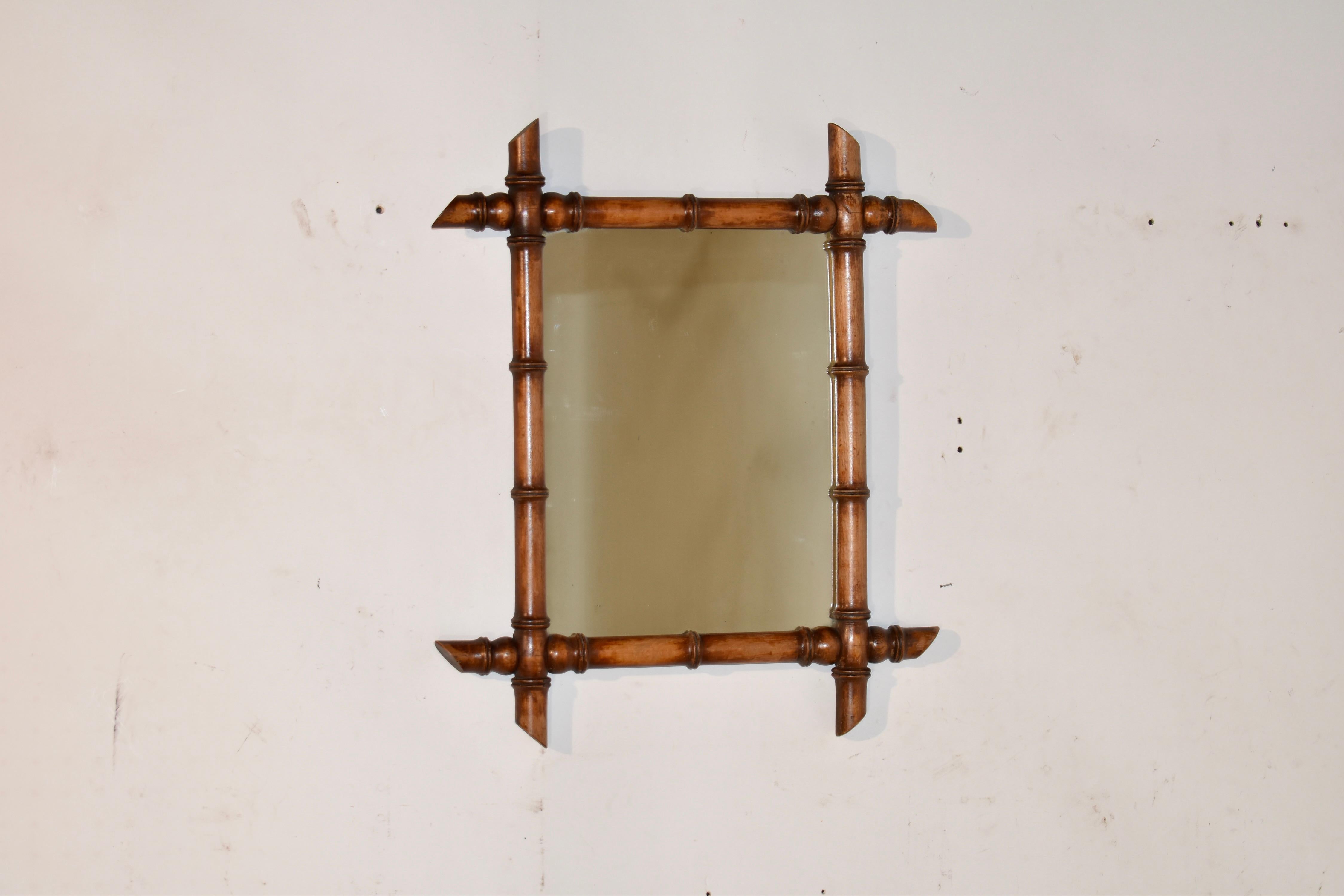 Late 19th century faux bamboo turned mirror frame from France.  The frame is turned from cherry, and is surrounding a central glass mirror. These are great accessories to warm up any decor.