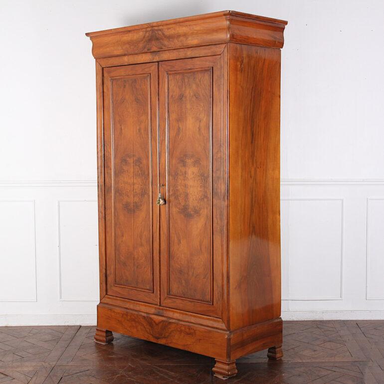 19th Century French figured walnut two-door armoire, each door with dramatically-figured book-matched veneer work, the interior with shelves, one with two fitted small drawers. Simple lines to this well-proportioned piece and with a lovely original