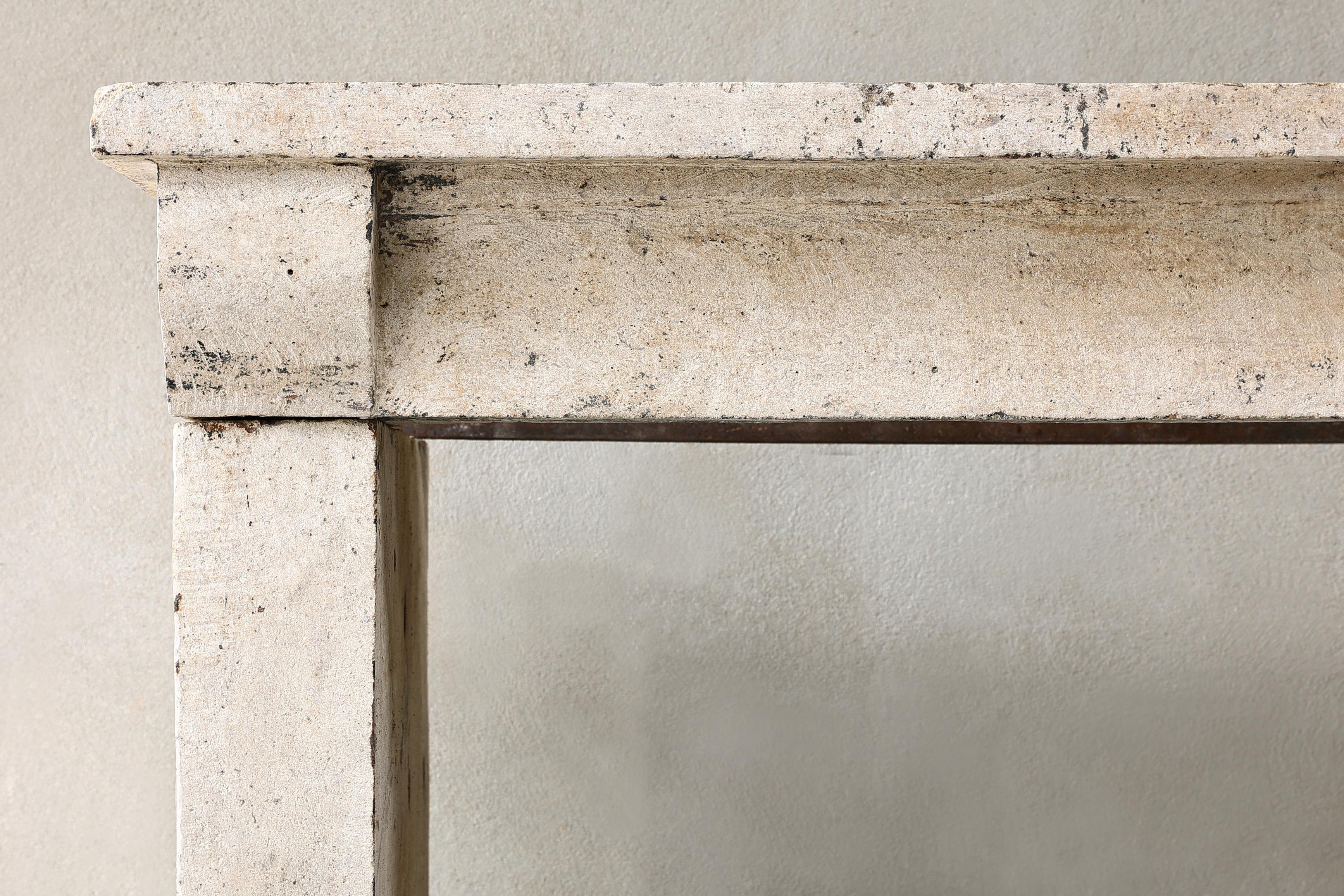 19th Century 19th century French fireplace of limestone in a simple style