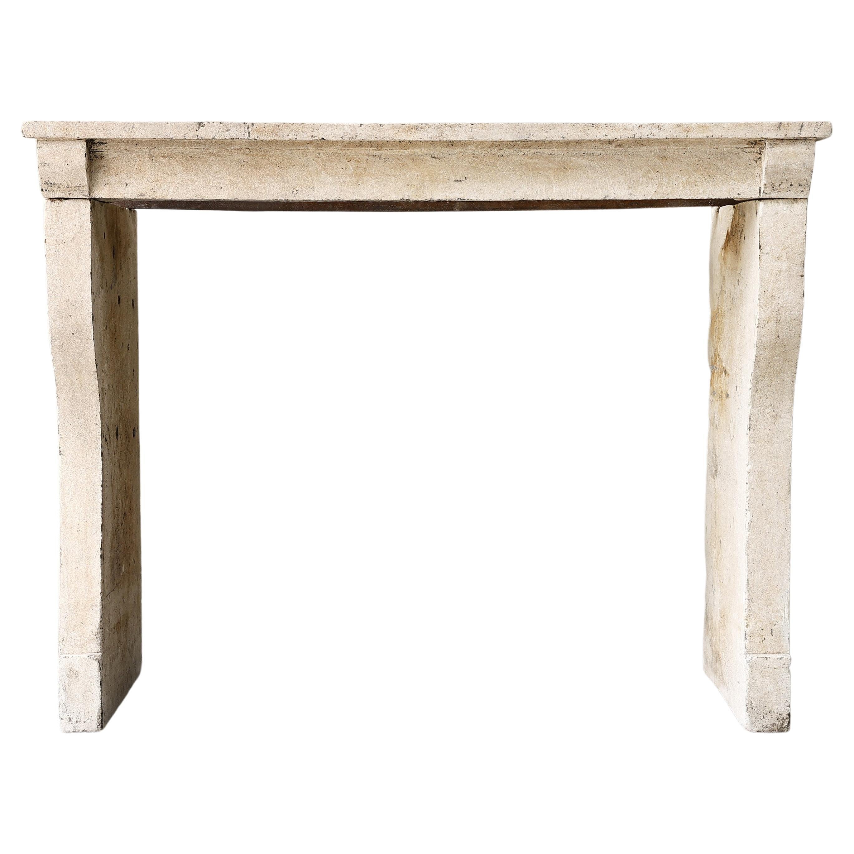 19th century French fireplace of limestone in a simple style