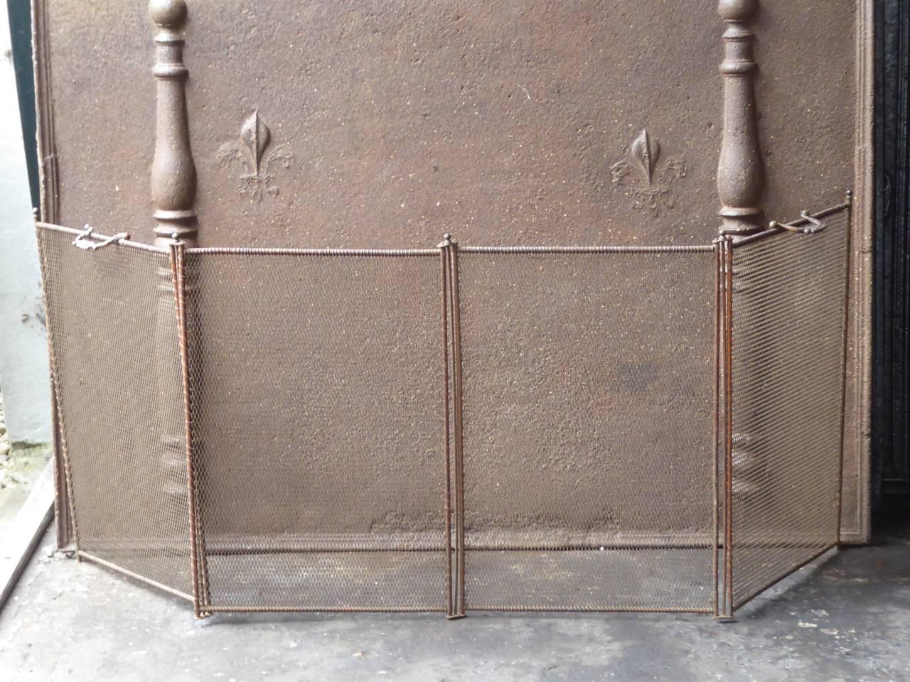 19th century, French fireplace screen made of iron and iron mesh.

We have a unique and specialized collection of antique and used fireplace accessories consisting of more than 1000 listings at 1stdibs. Amongst others, we always have 300+ firebacks,