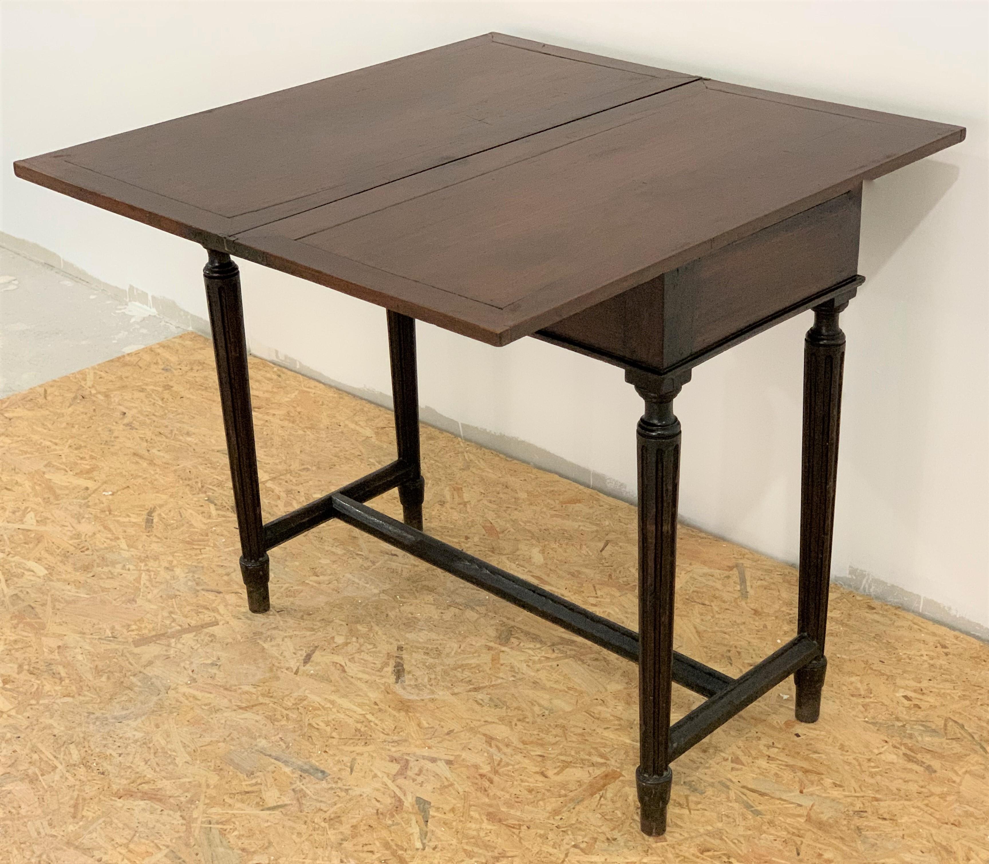 19th century French fold over mahogany games or tea table with original finish. The rectangular top raised on straight legs. 

Opened measurements: 31.5 in x 31.89 in.