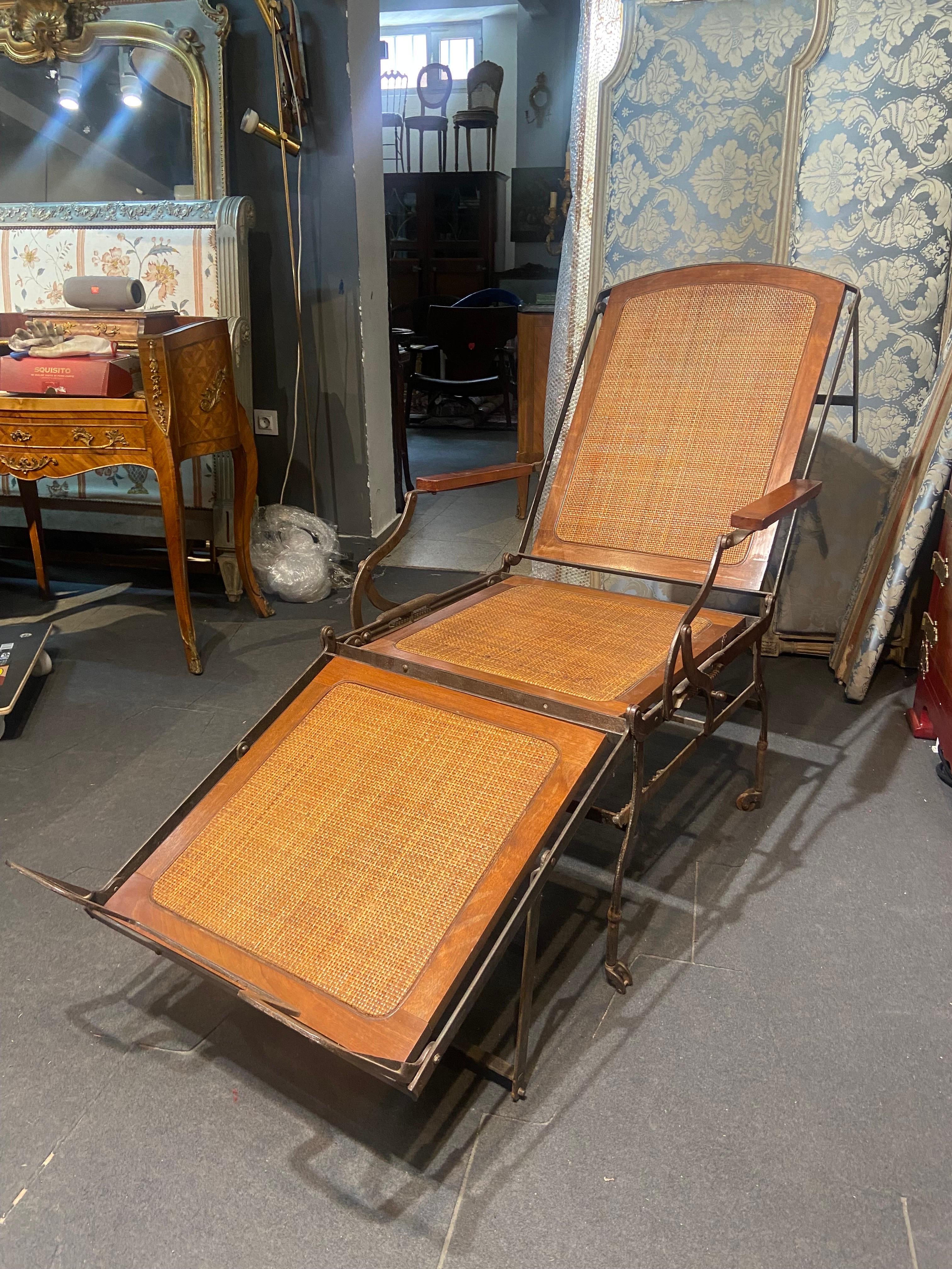 19th Century French wrought iron adjustable folding chaise lounge.
This beautiful antique metal campaign chaise can be positioned into three different positions - as a chair, a traditional chaise, and a flat daybed.
Authentic condition with no