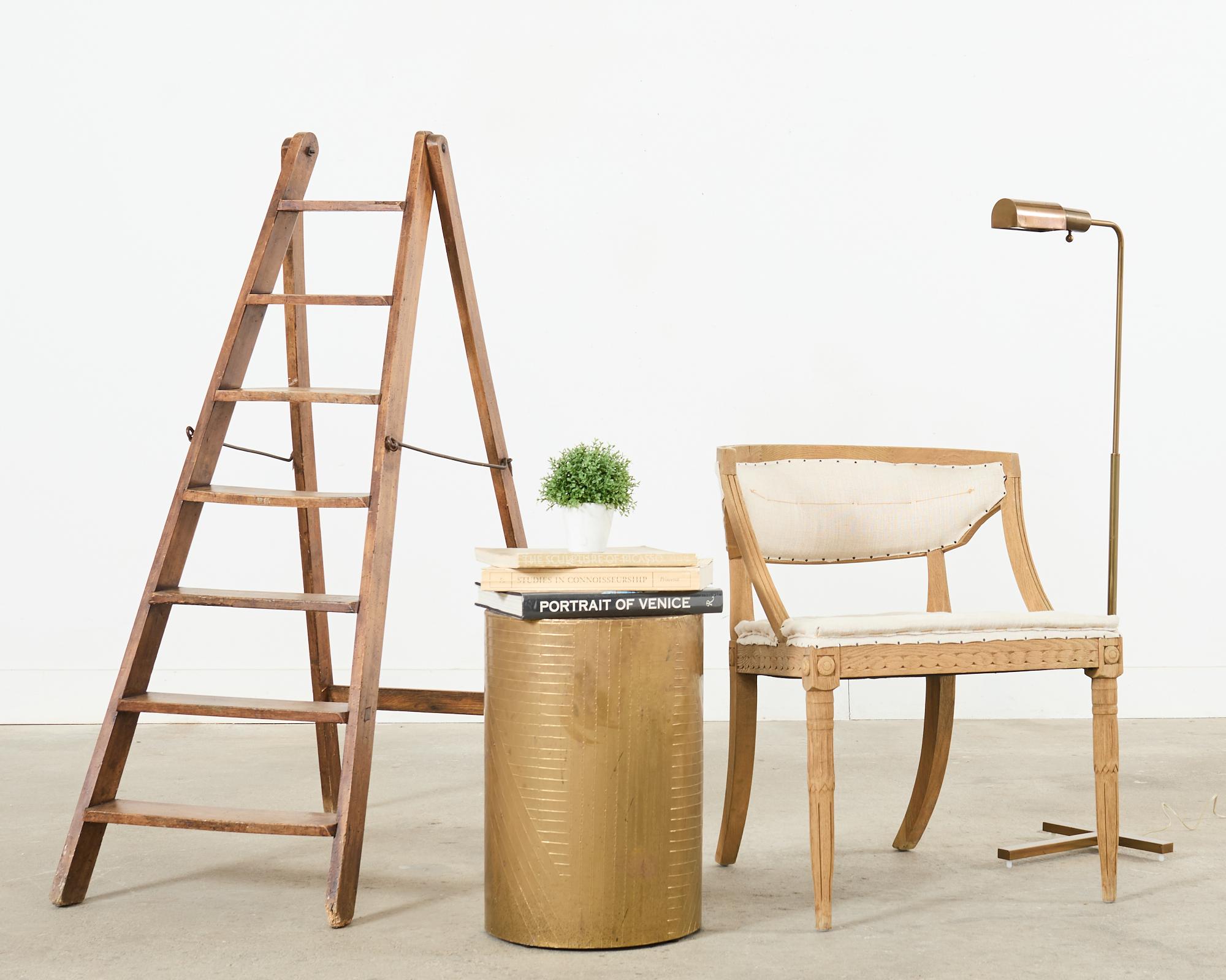 Handsome late 19th century French country folding library ladder. Featuring a handcrafted design with seven rungs or steps and iron hardware. From an estate in Santa Barbara, CA.