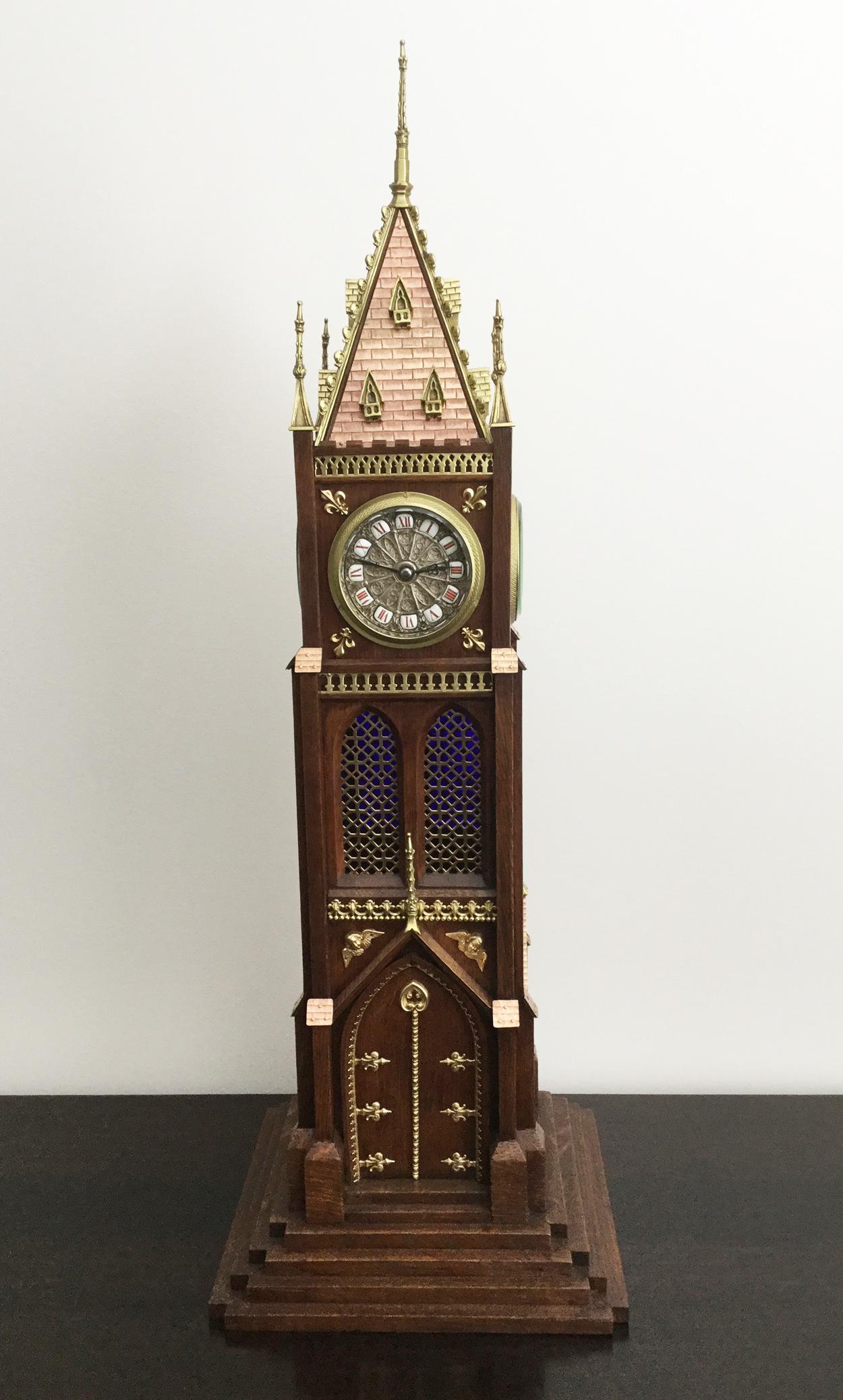 A magnificent large rare novelty Blumberg four face tower clock, circa 1880.

The walnut case topped with a copper roof and all-over brass detailing, the long tower windows backed by blue glass, the decorative silver faces with ceramic inserts