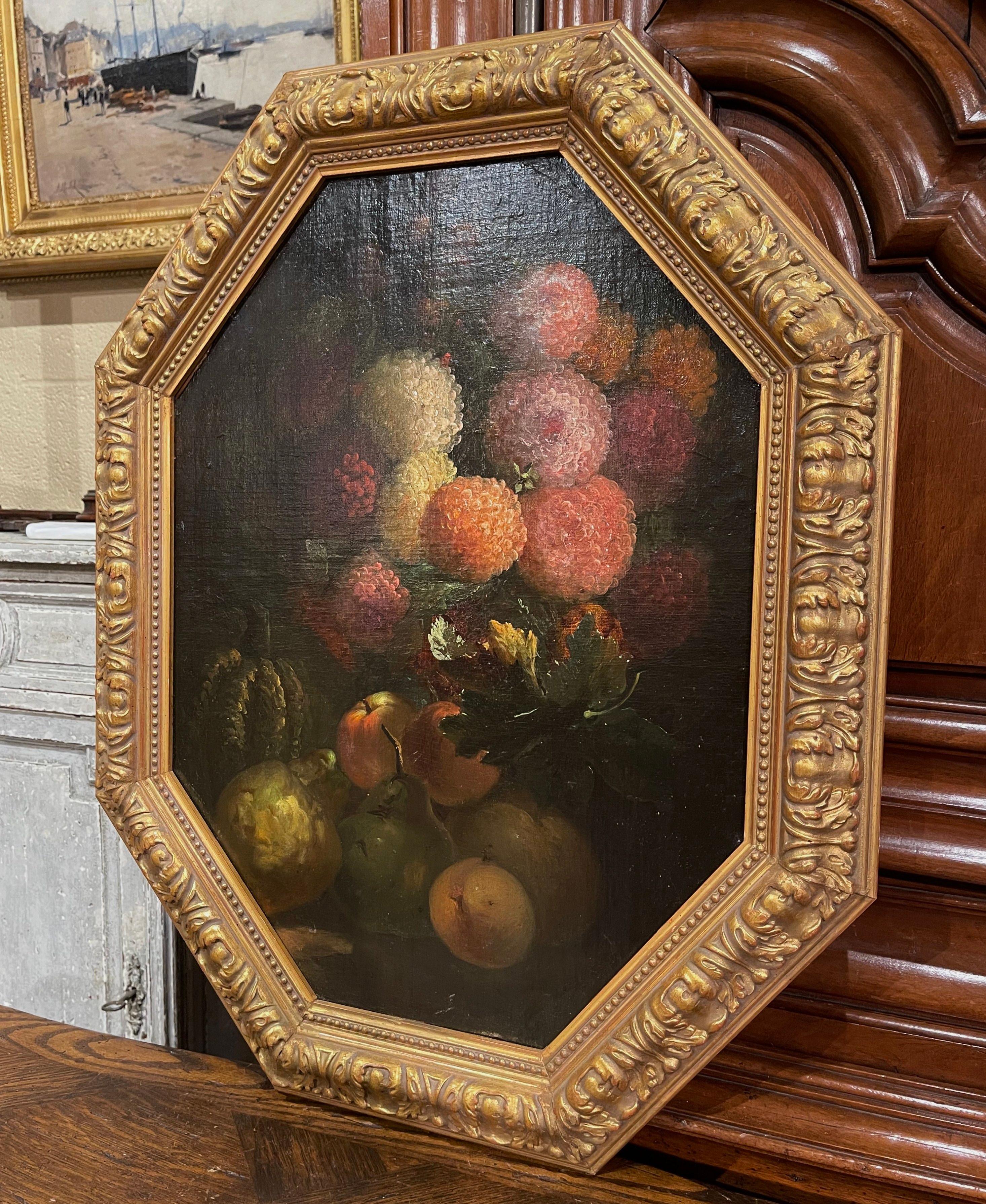 Place this antique painting in a living room, bedroom, or on an office wall. Created in France circa 1880, the artwork is set in a unique octagon-shaped carved gilt frame. The piece painted on board depicts an elegant floral arrangement of bustling
