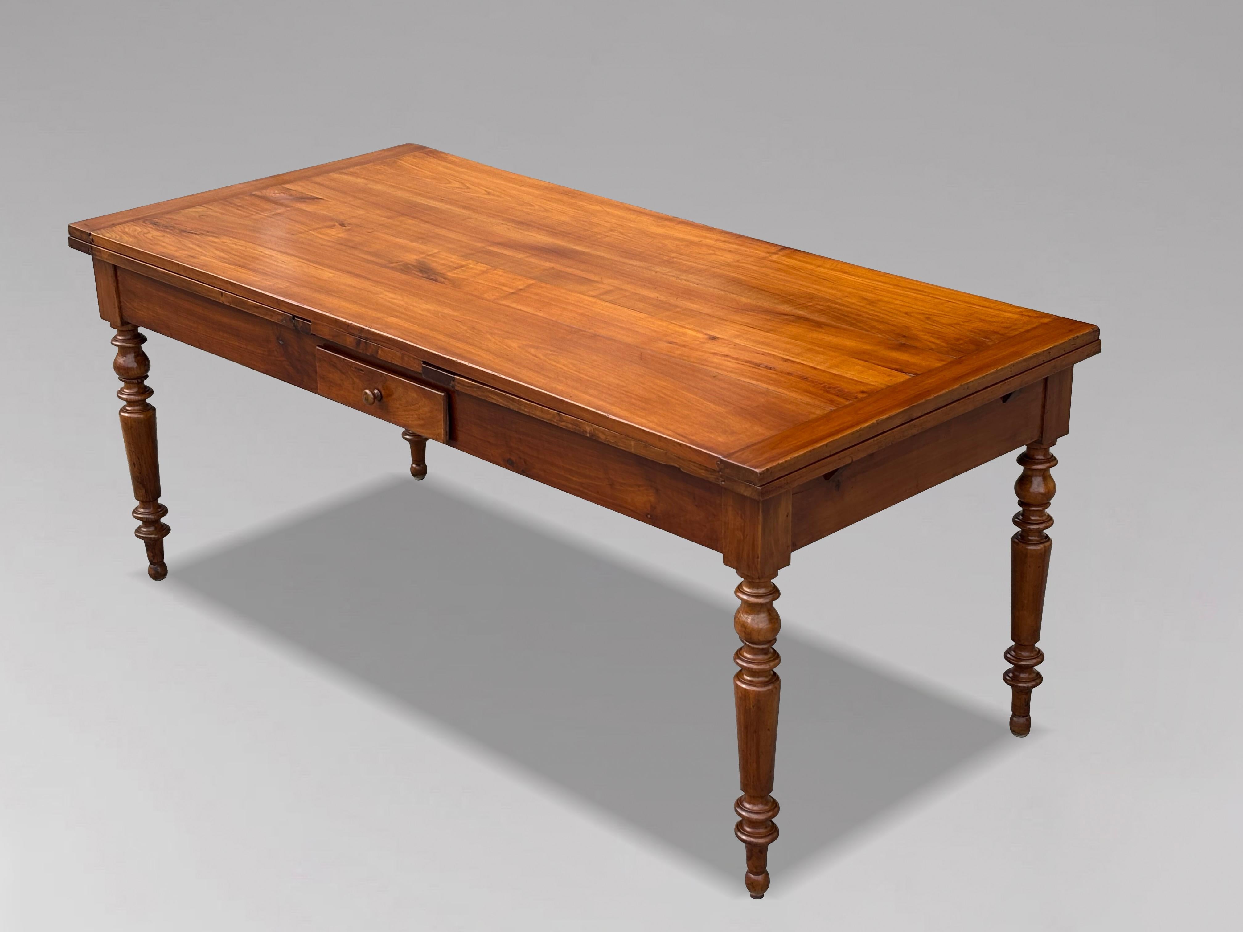 A Charming 19th Century French Fruitwood Draw-Leaf Dining Table

A good 19th century French double extender country farmhouse dining table in cherry and chestnut that will seat 10 people when fully opened. A rectangular solid fruitwood plank top