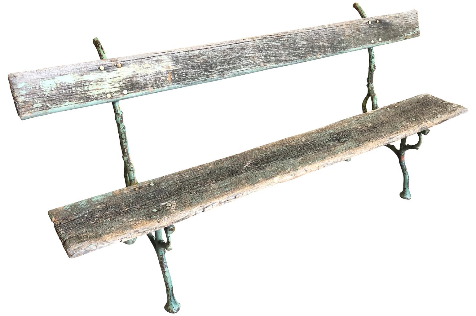 A very charming late 19th century garden bench from the Provenance region of France. Beautifully constructed from wonderful cast iron faux bois base and wooden seat and back. Fabulous patina.