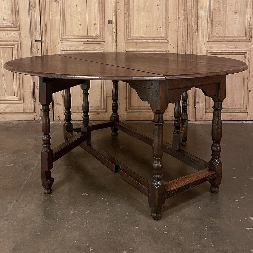 19th Century French Gate Leg Drop Leaf Dining Table ~ Sofa Table will make a versatile and efficient addition to your home! Hand-crafted from dense, old-growth oak to last for generations, it features a solid plank top that is oval in shape when