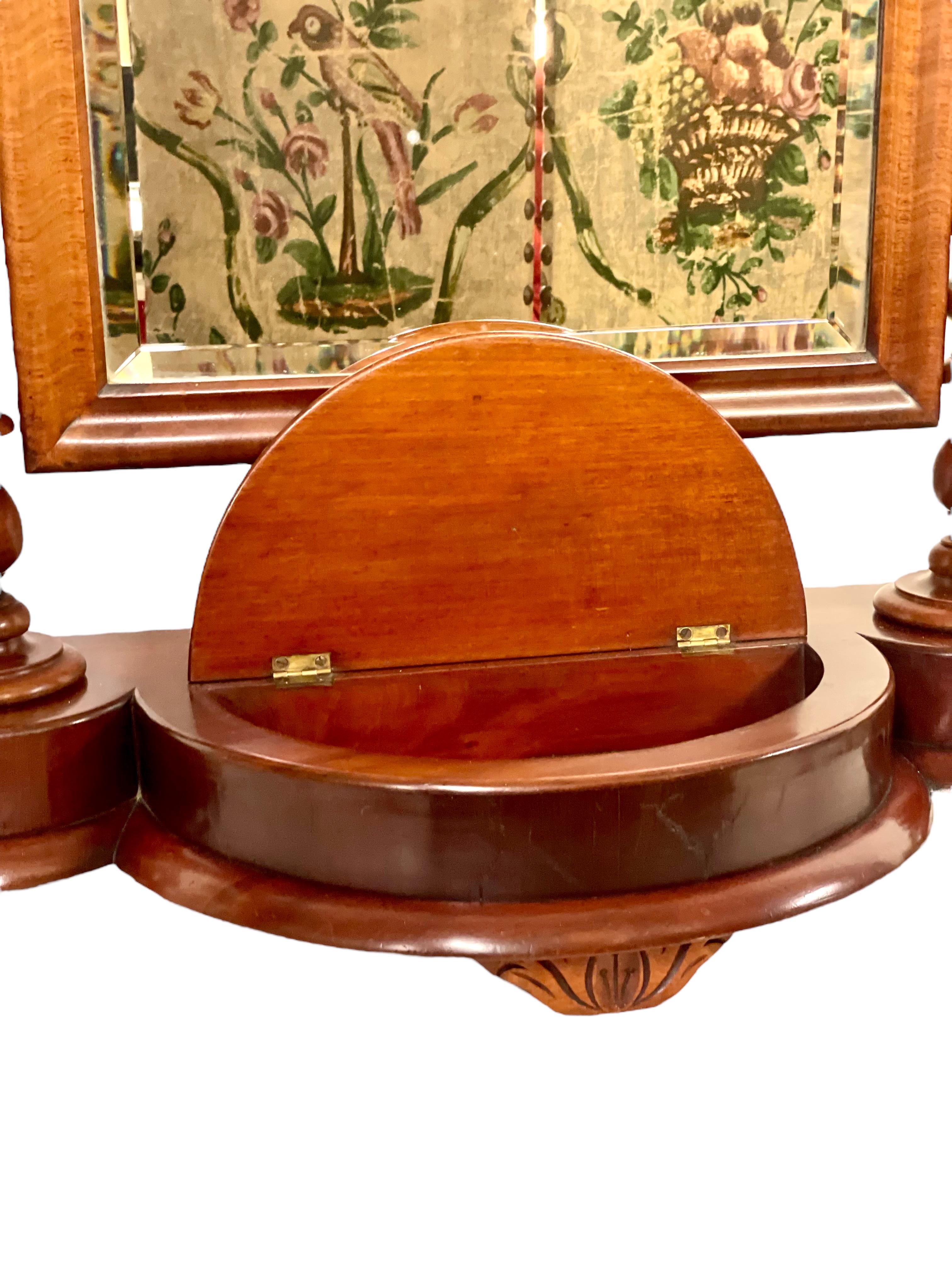 An antique gentleman's vanity toilet mirror, or 'Psyche', dating from the 19th century and beautifully crafted from gleaming mahogany. This tilting table-top mirror is full of character, with wonderful barley-twist uprights on either side of its