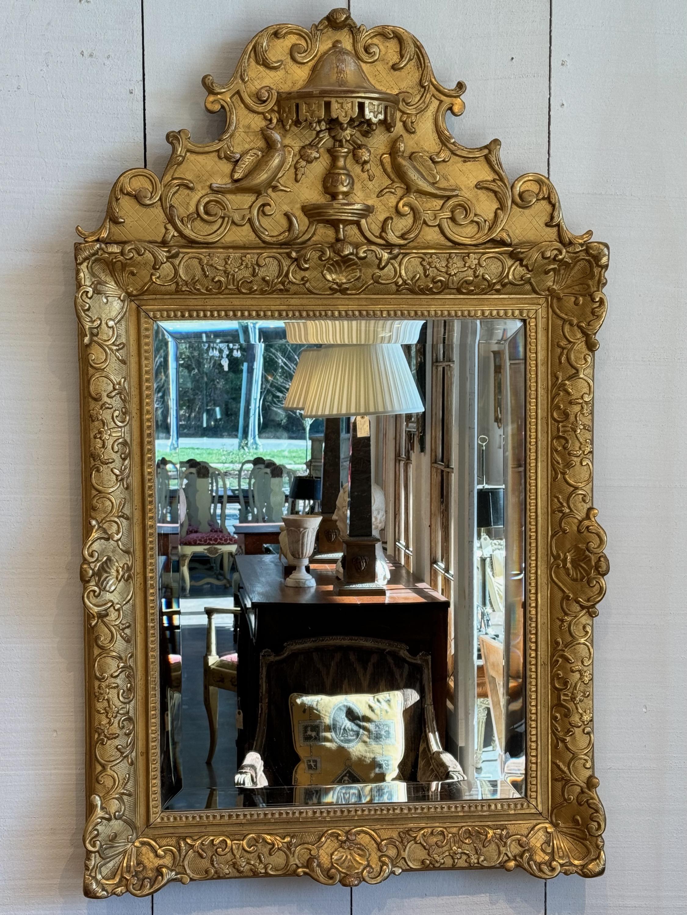 Look at this exquisite gilded mirror. Featuring birds.