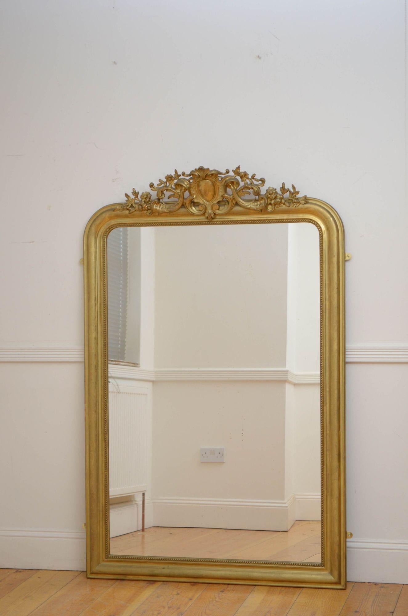 Sn5277 Superb French giltwood wall mirror, having original glass with some imperfections in beaded and gilded frame with and fabulous crest with scrolls and flowers to the centre and etched flowers decoration throughout. This antique mirror retains