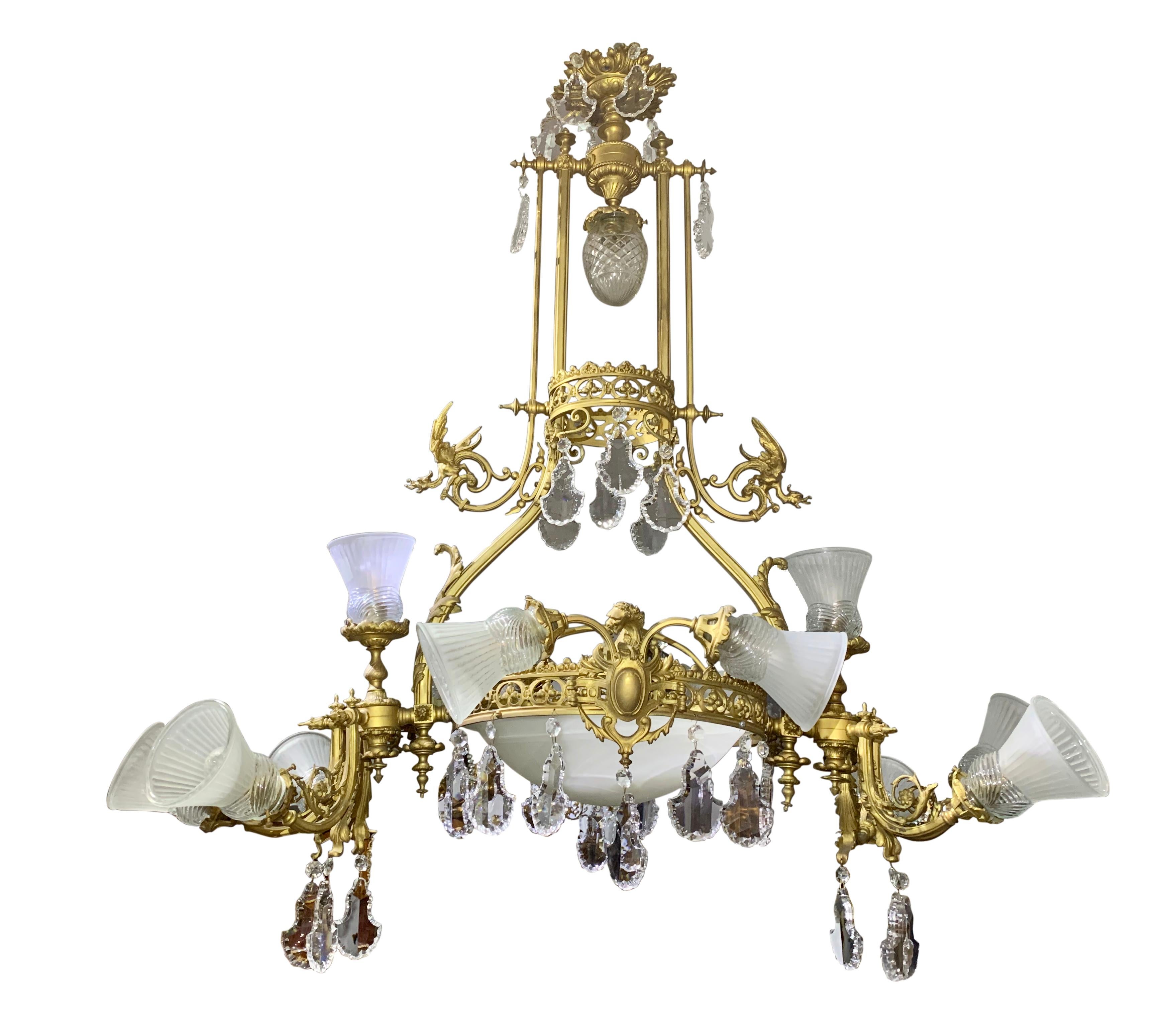 A large late 19th century French Belle époque neoclassical revival style gilt bronze and crystal twelve-light oval shaped chandelier with dragons.

Paris, circa 1890

Height: 51