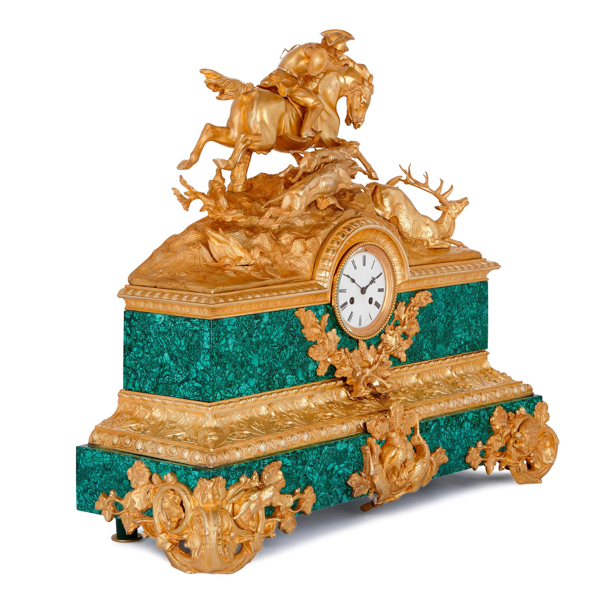 This exceptional gilt bronze mantel clock is finely-cast and elegantly veneered in malachite, and is especially notable for the excellently-sculpted hunting scene which adorns the upper part of the clock case.

The hunting scene shows a man with a