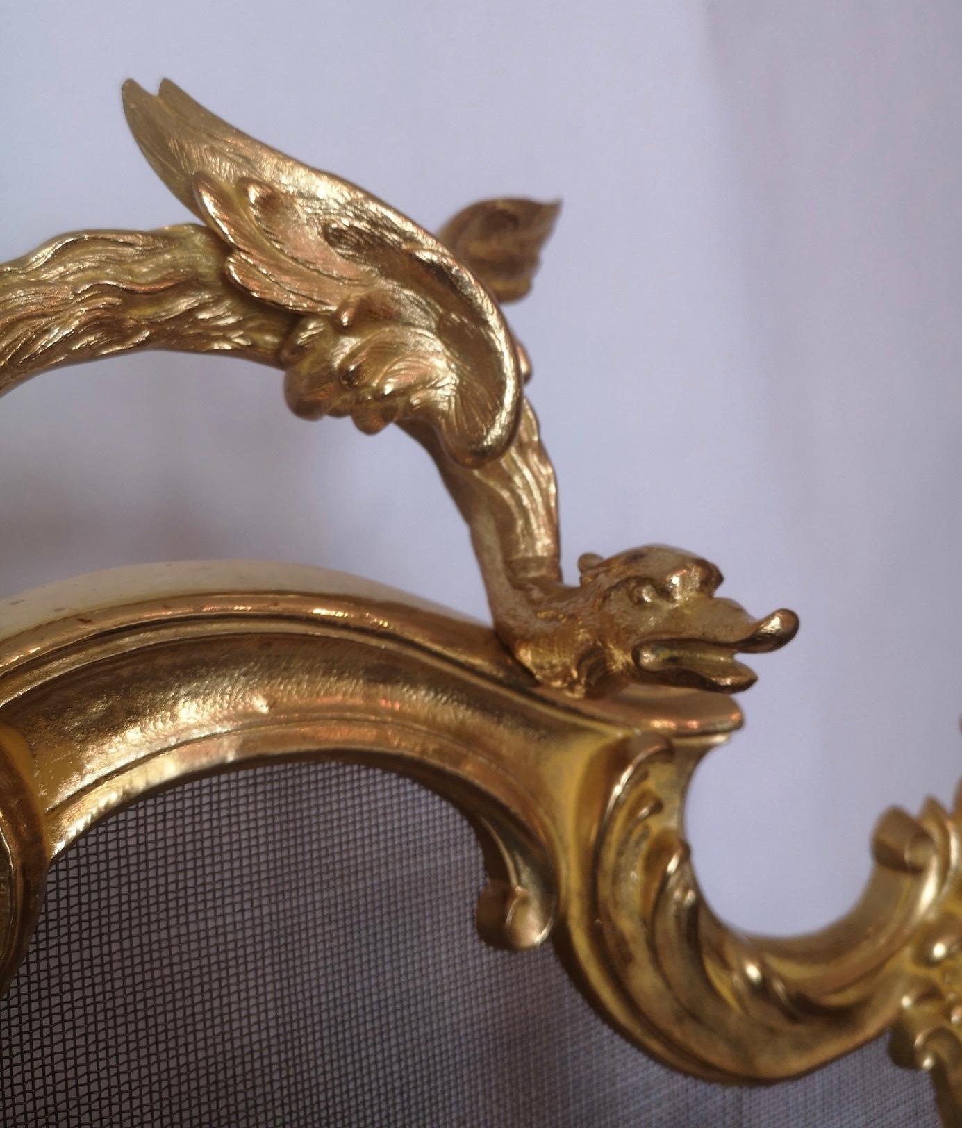 A 19th century French gilt bronze fire screen, the Rococo frame topped by a winged mythical beast, a floral centre and standing on scrolling feet. The wire mesh in excellent condition.
French, circa 1890s.