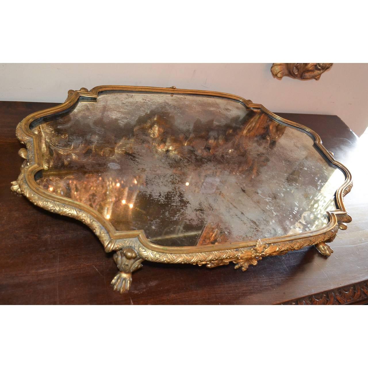 Beautiful gilt bronze and mirrored tray/platter that was made in France, circa 1870.
Measure: The plateau is 27 inches wide x 18.5 inches deep x 3.5 inches in height.
Very nice condition. Mirror intact.