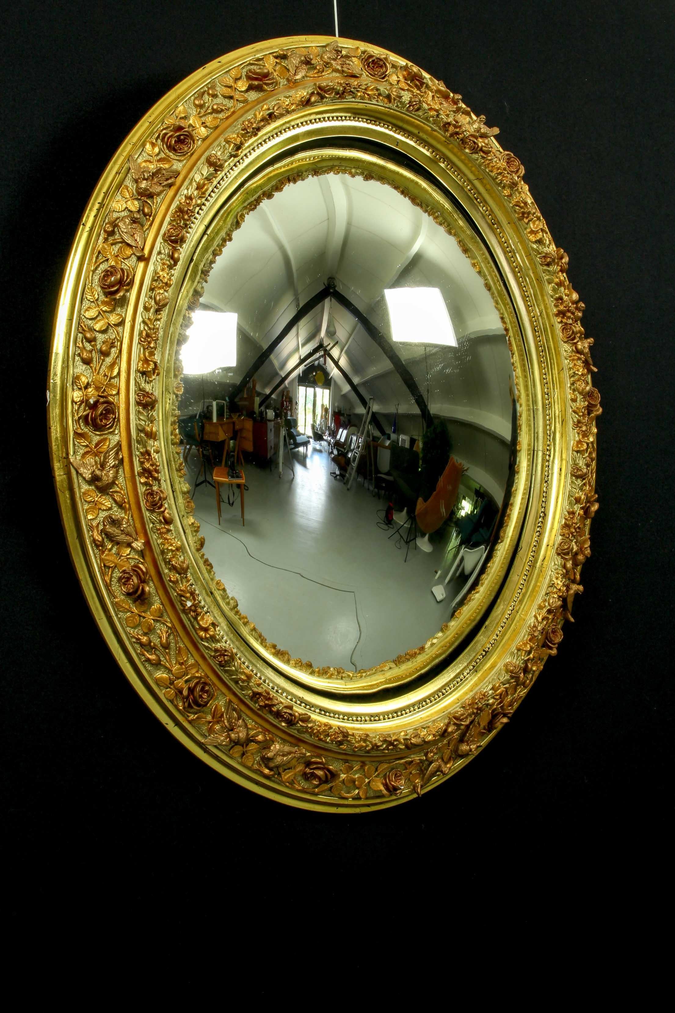 19th century French giltwood convex butler mirror decorated with roses and birds. This is a very good looking and highly decorative piece. The frame is gilt plaster over wood which was popular from the late Victorian era onwards, it has age related