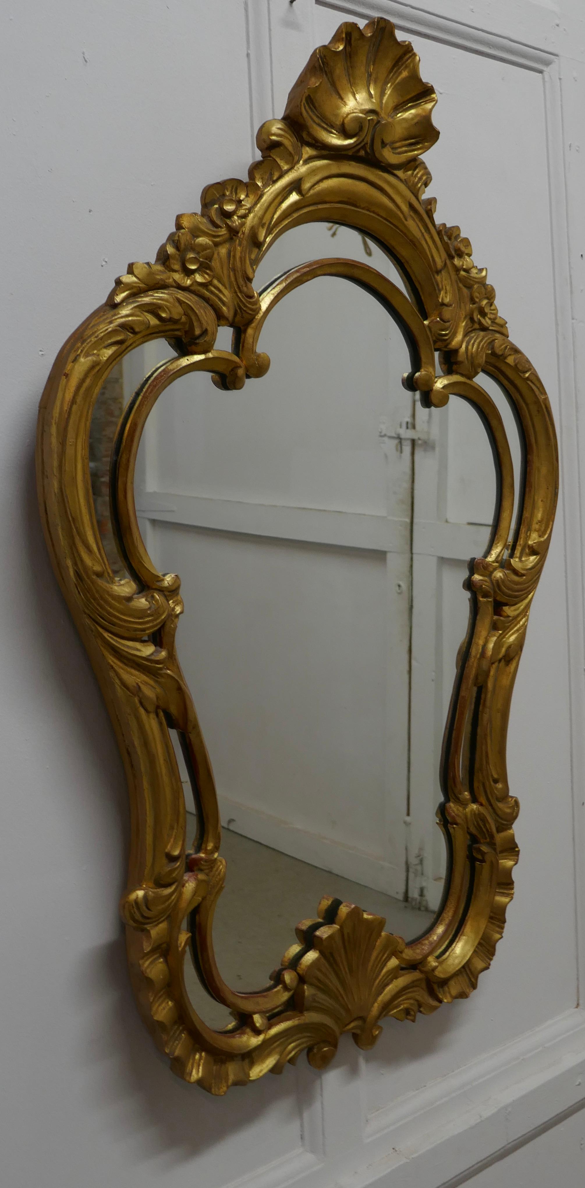 19th century French gilt console mirror


This is a beautifully decorative gold frame mirror it is an unusual shape with gilded carving
The frame is pierced and carved with scrolls and shells, the gilt finish is very slightly faded but all