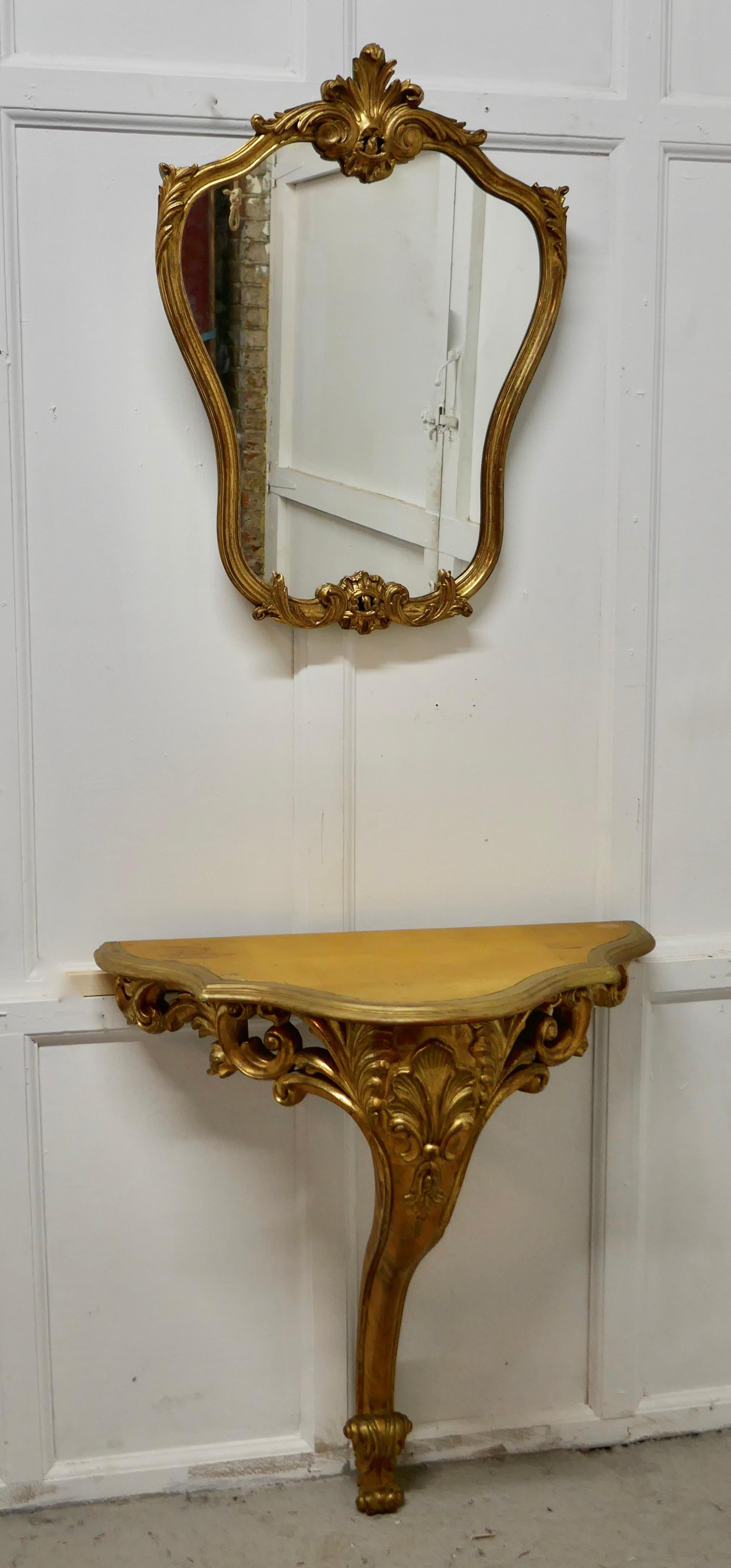 19th century French gilt console or hall table and matching mirror set

This is a very attractive set, the table is set on a single carved leg, with a matching shield shaped mirror
A really attractive pair in good condition, with some scuffing to