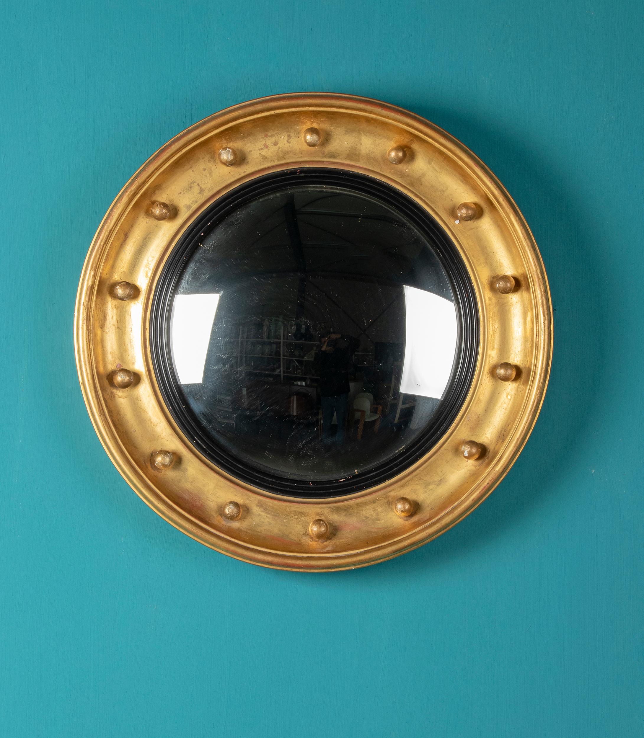 Beautiful antique French convex mirror. The frame is made of wood, decorated with plaster and gilding.
The glass of the mirror is convex, intended to have a good view of the entire room. The mirror is in very beautiful, original condition and has a