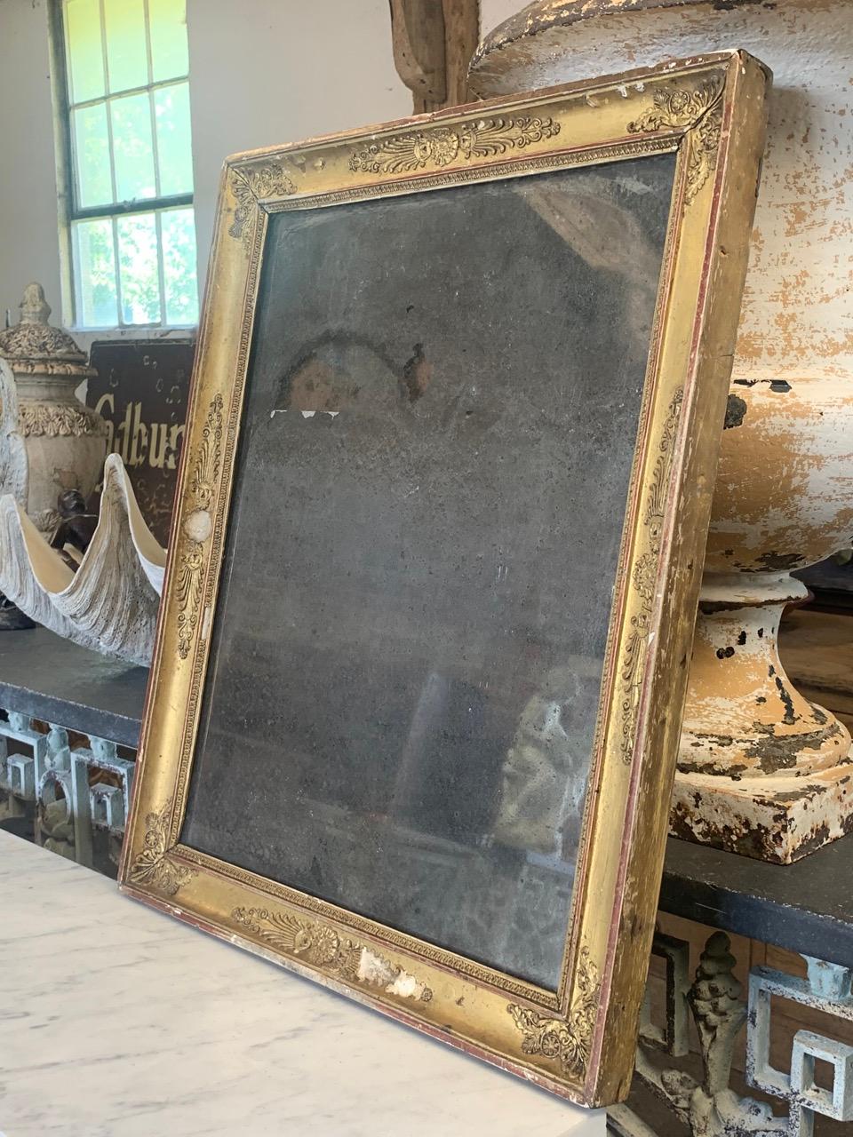 A lovely 19th century French gilt framed mirror in nice distressed condition with original foxed glass mirror plate. The wood and gesso frame has nice wear to the gilding giving it a great decorative look. It has its original pine back boards.