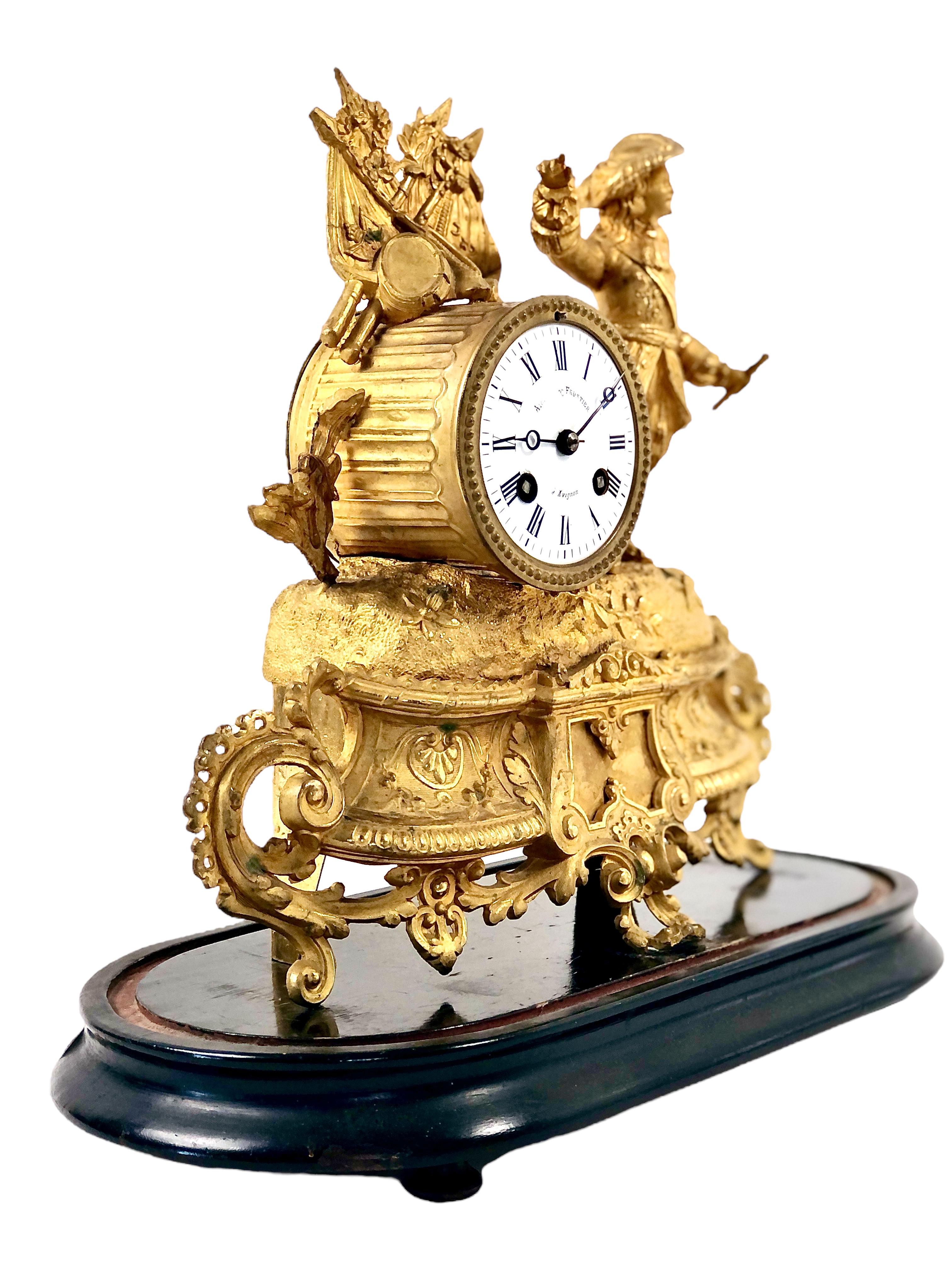 An intricate and beautifully crafted 19th century French gilt mantel clock under a glass dome on a wooden base. Dating from the Napoleon III period, the figurine depicts the illustrious and victorious career of Henri de La Tour d’Auvergne, Viscount