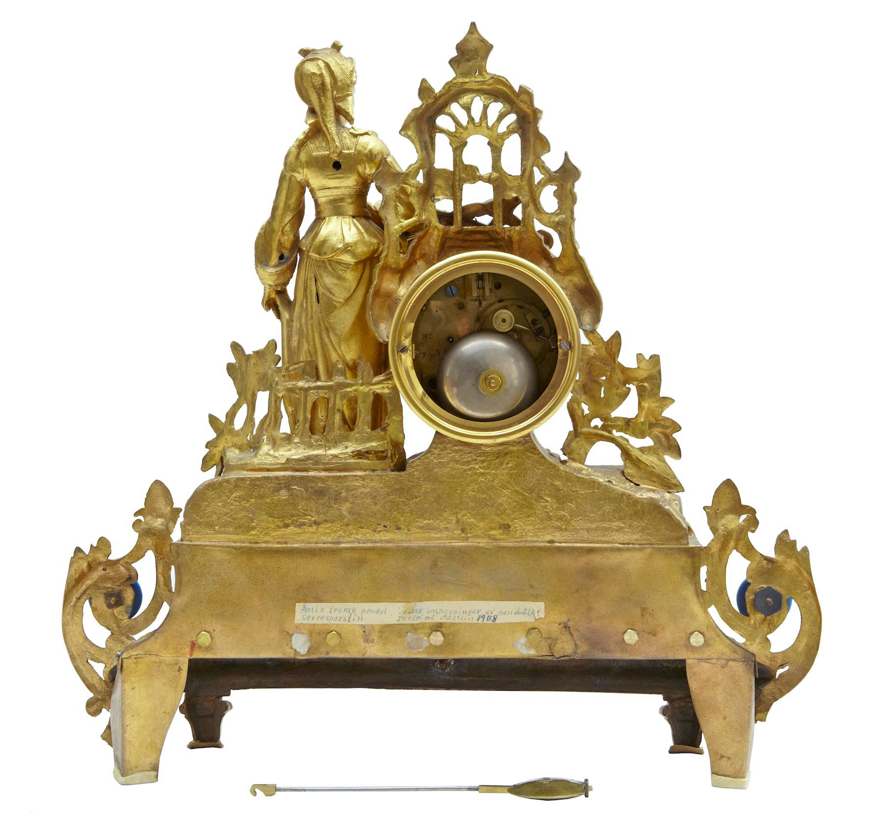 19th century French gilt mantel (fireplace) clock with sèvres plaques, circa 1890.

Fine quality ornate French clock surmounted with a lady in traditional French dress leaning on an architectural window and ship building tools. Enamel clock face
