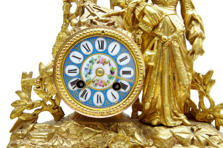 19th century french gilt mantle clock with Sevres plaques circa 1890.

Fine quality ornate french clock surmounted with a lady in traditional french dress leaning on an architectural window and ship building tools.  Enamel clock face with roman
